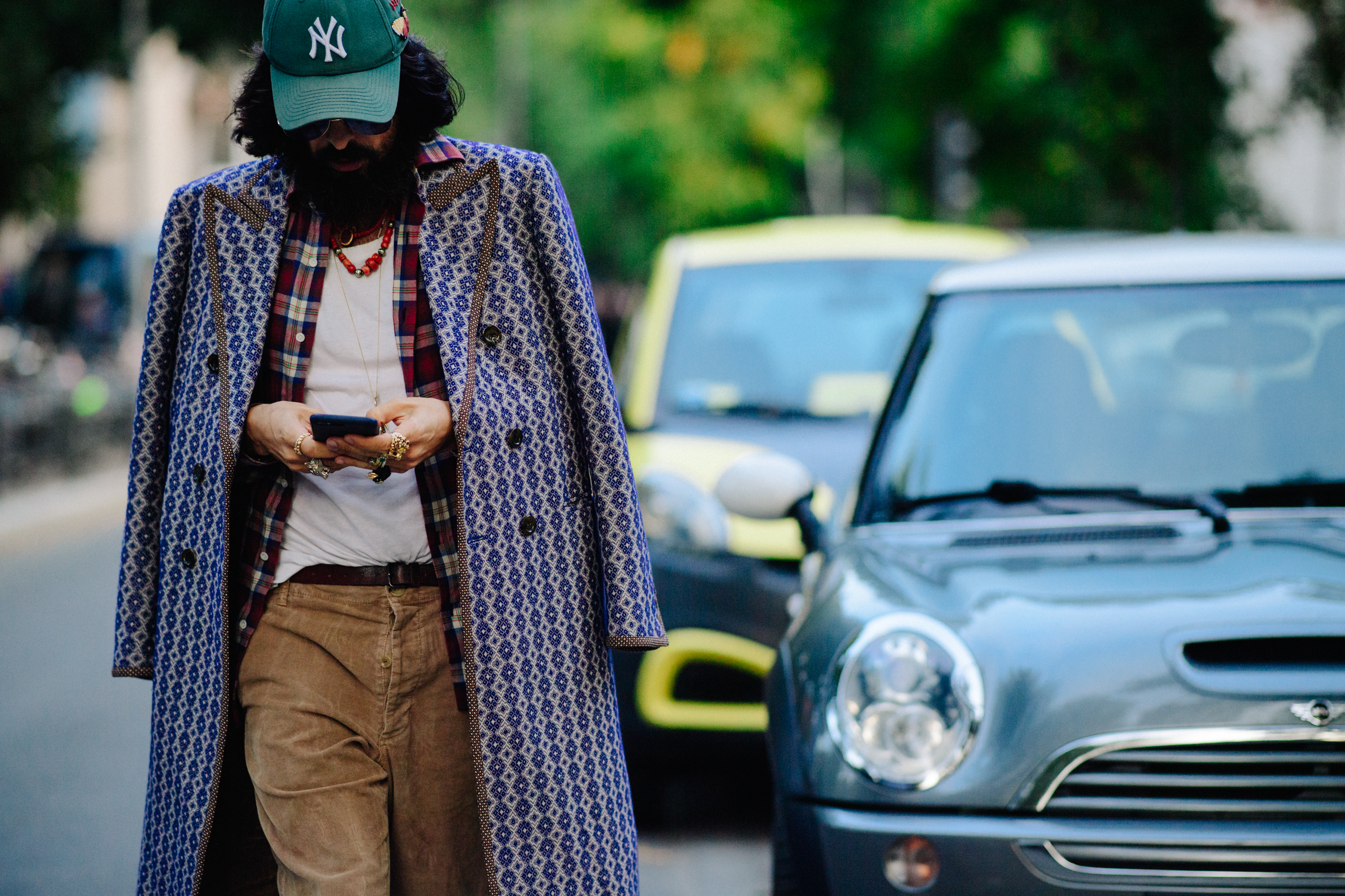 Man with colourful pattern coat over shoulders
