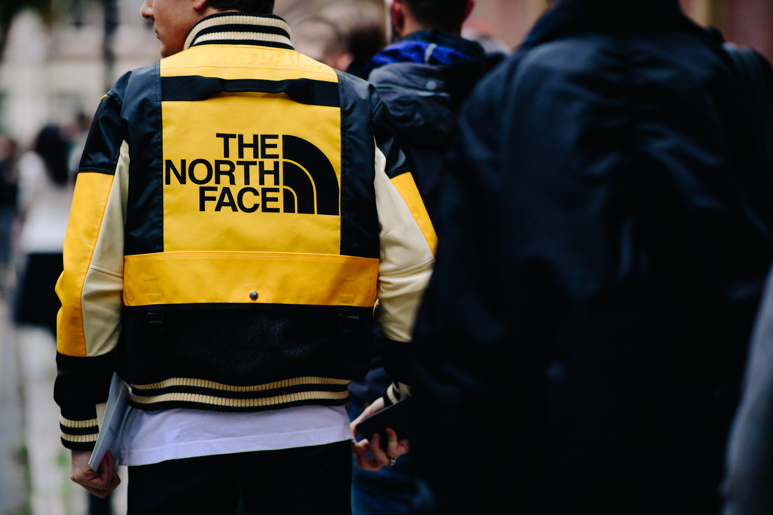 Italian buyer wearing yellow The North Face jacket