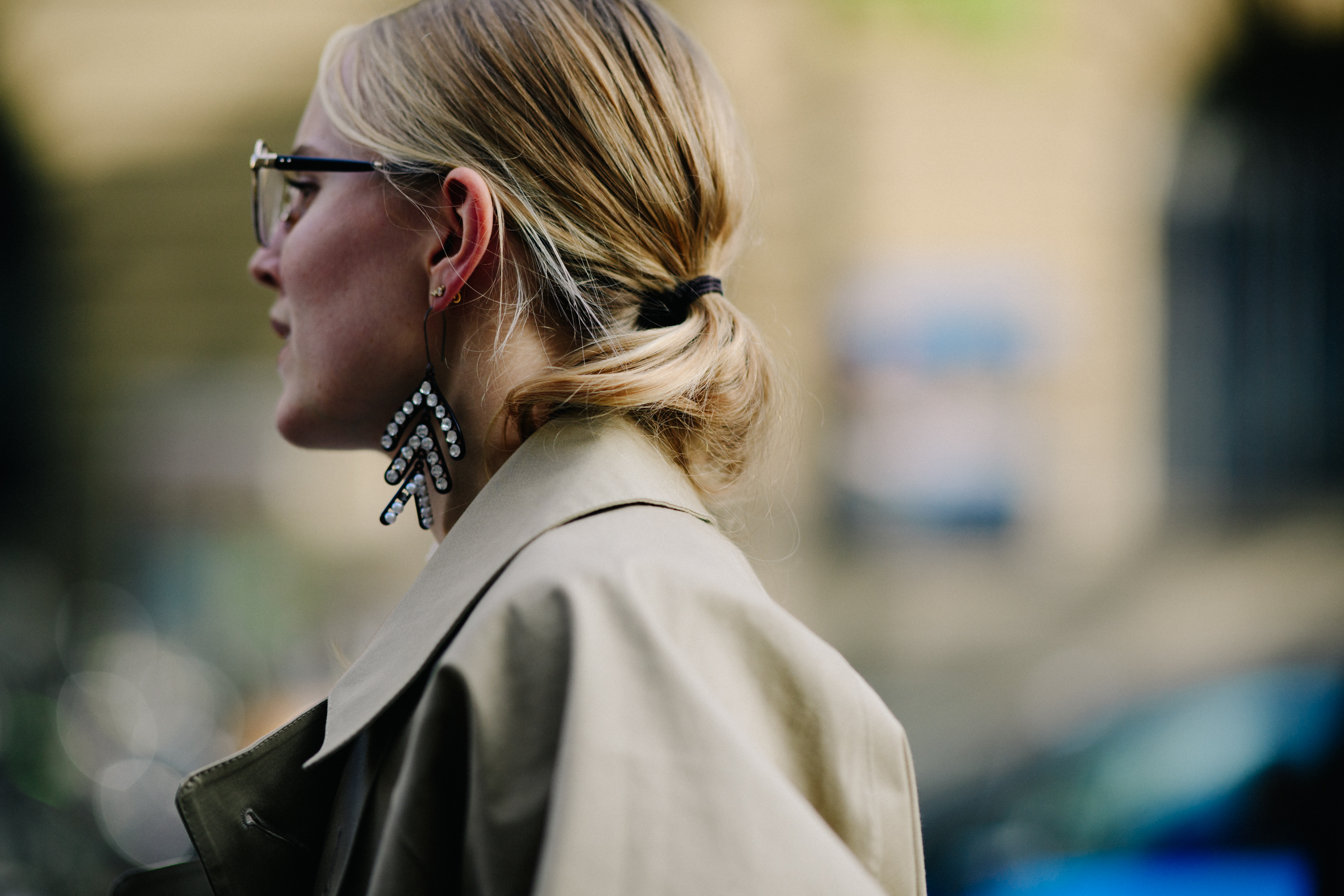 Blogger wearing beige coat and earrings