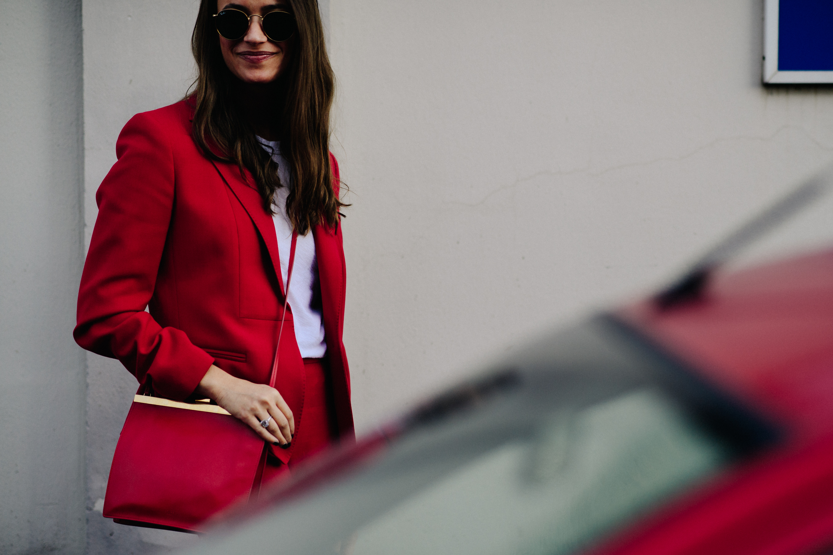 Woman in red jacket with red bag