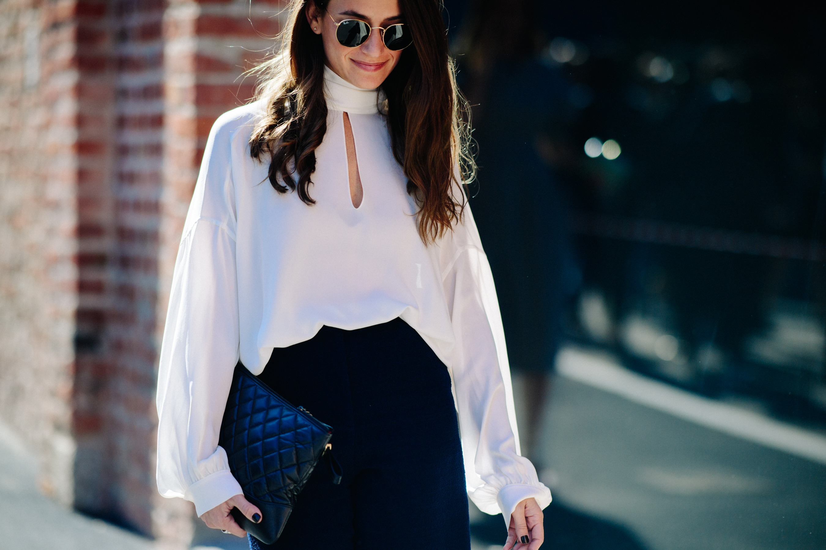 Woman wearing white long sleeve top