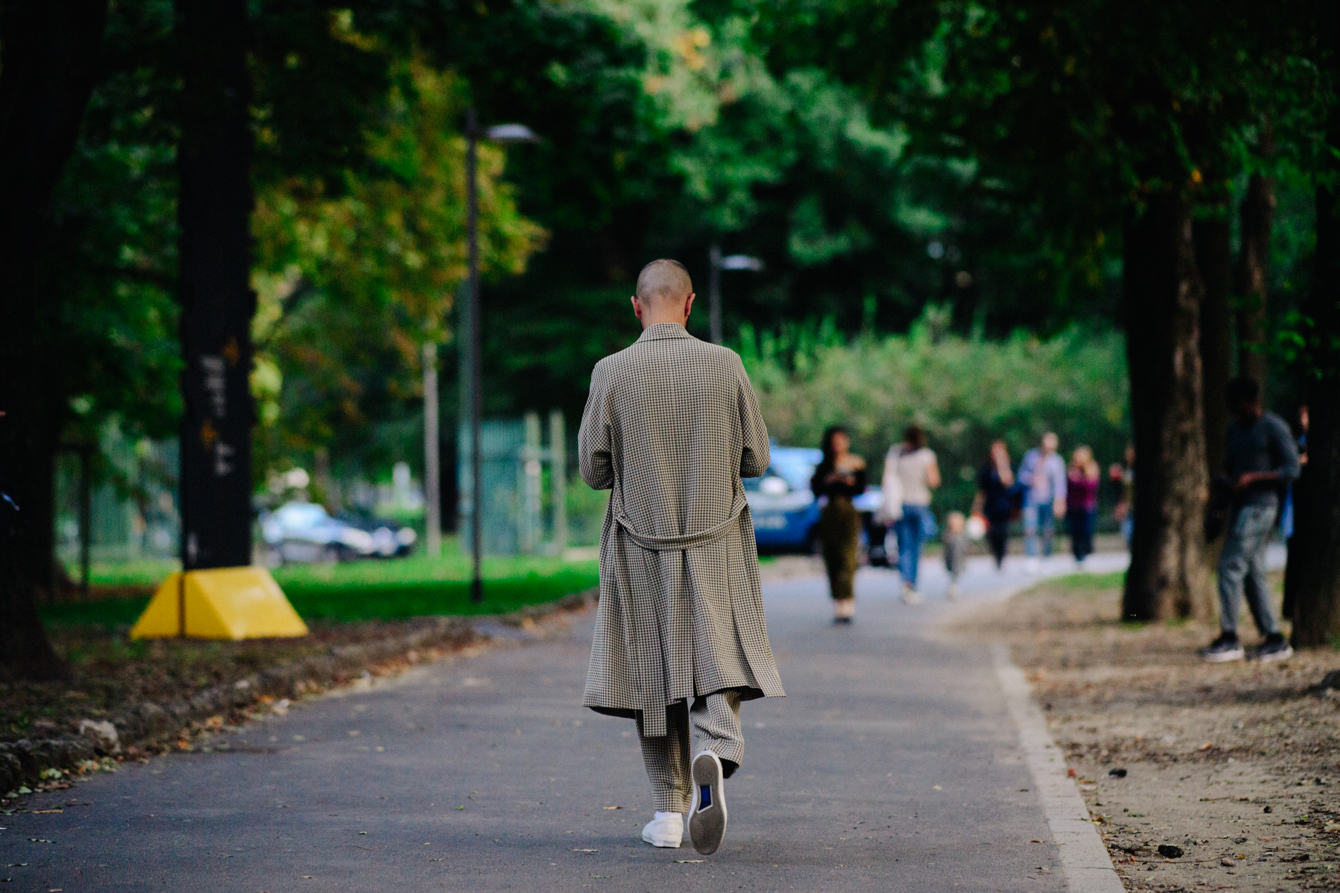 Man walking in long check outfit