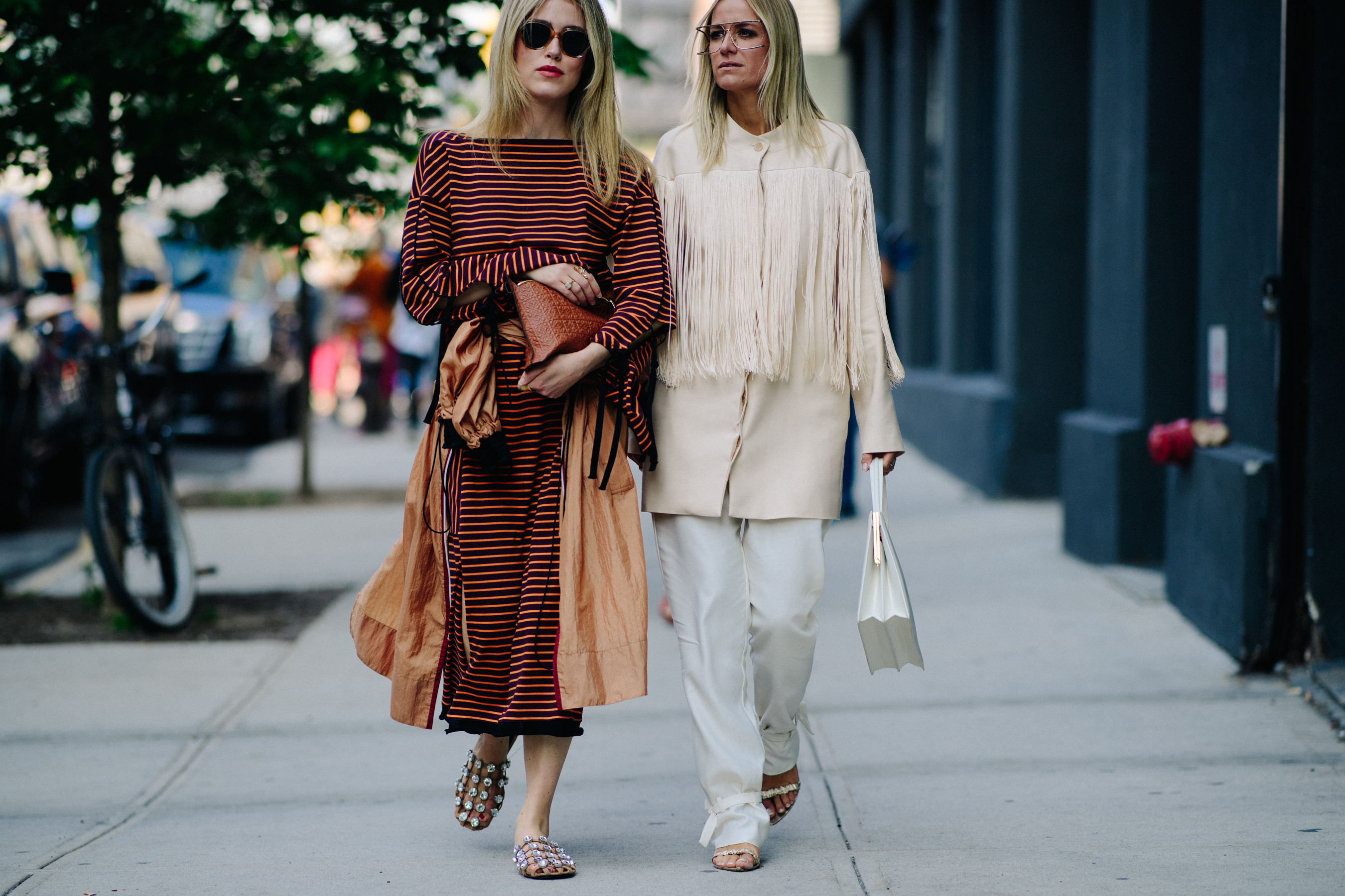 Two bloggers wearing dresses and coats