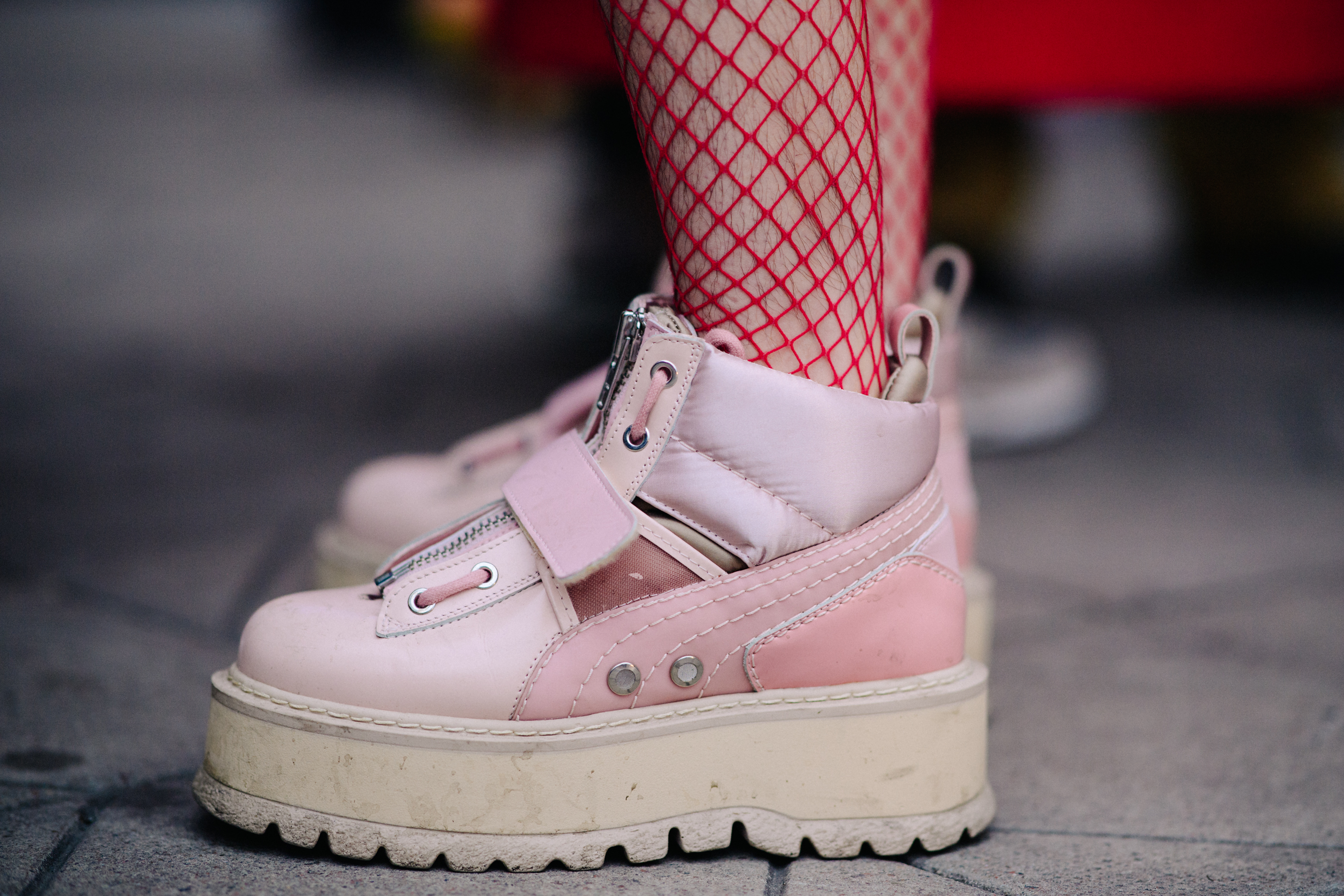 Woman wearing Fenty x Puma pink boots