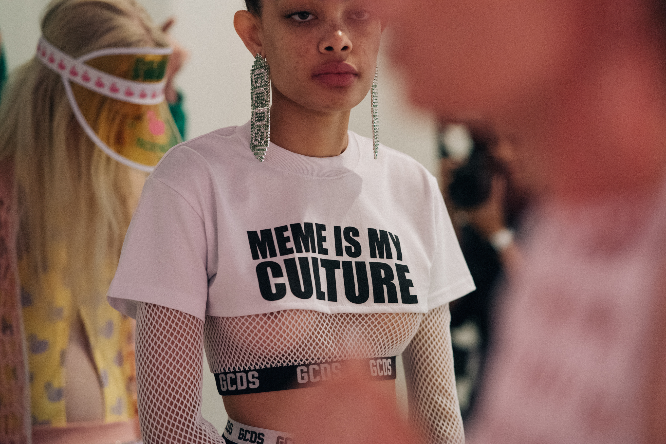 Model wearing pink and white before a show