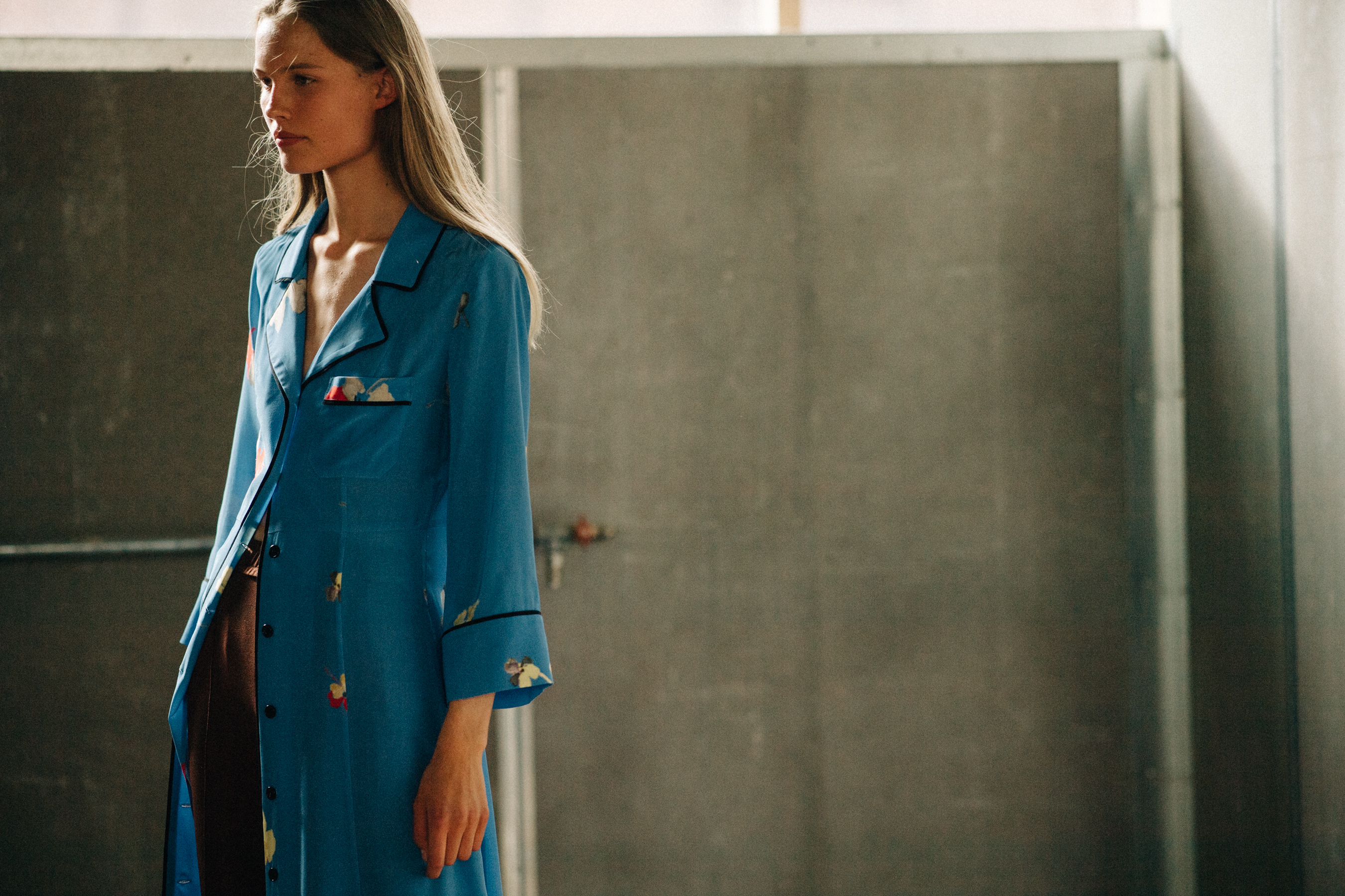 Model wearing blue robe before a show