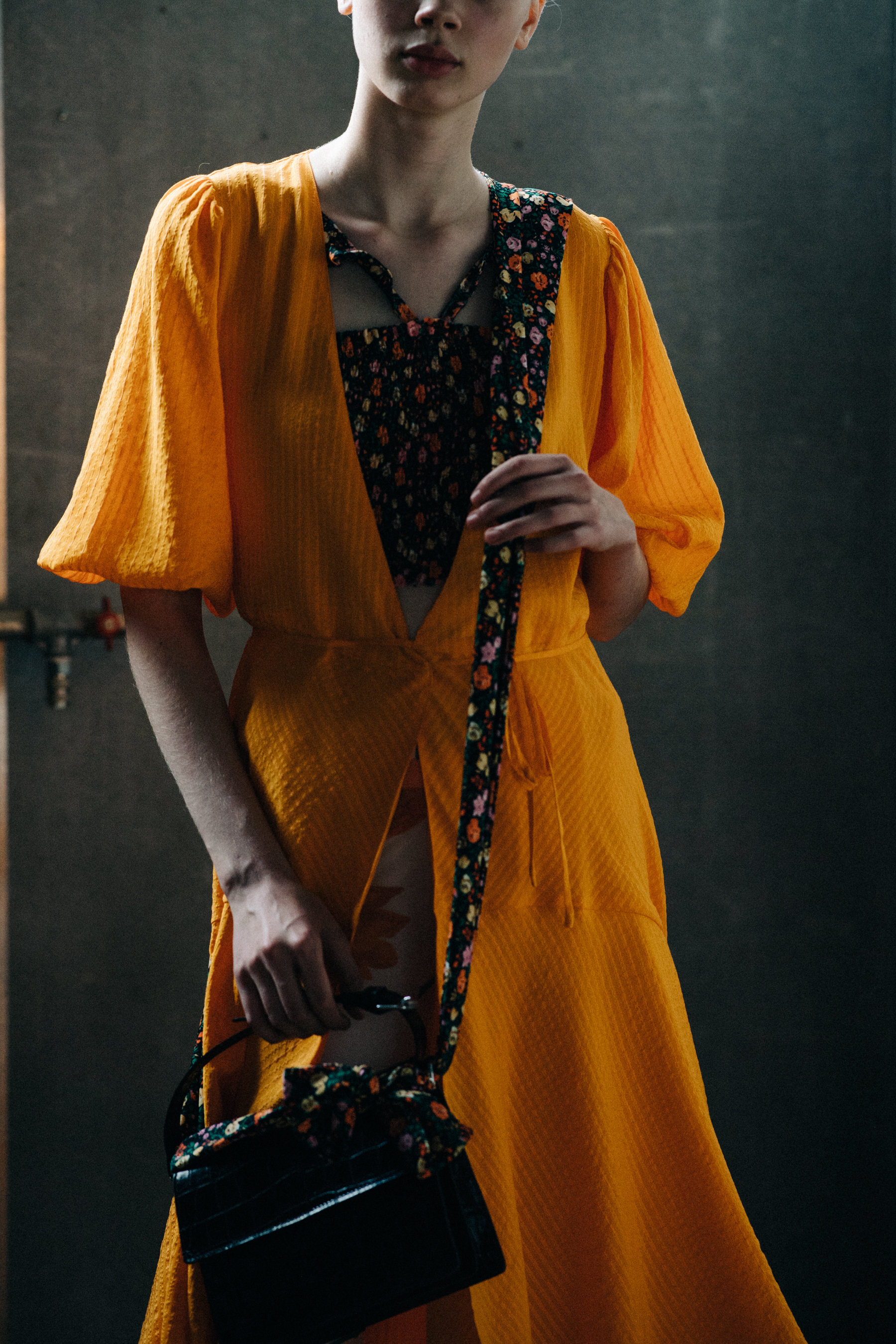 Model wearing orange dress