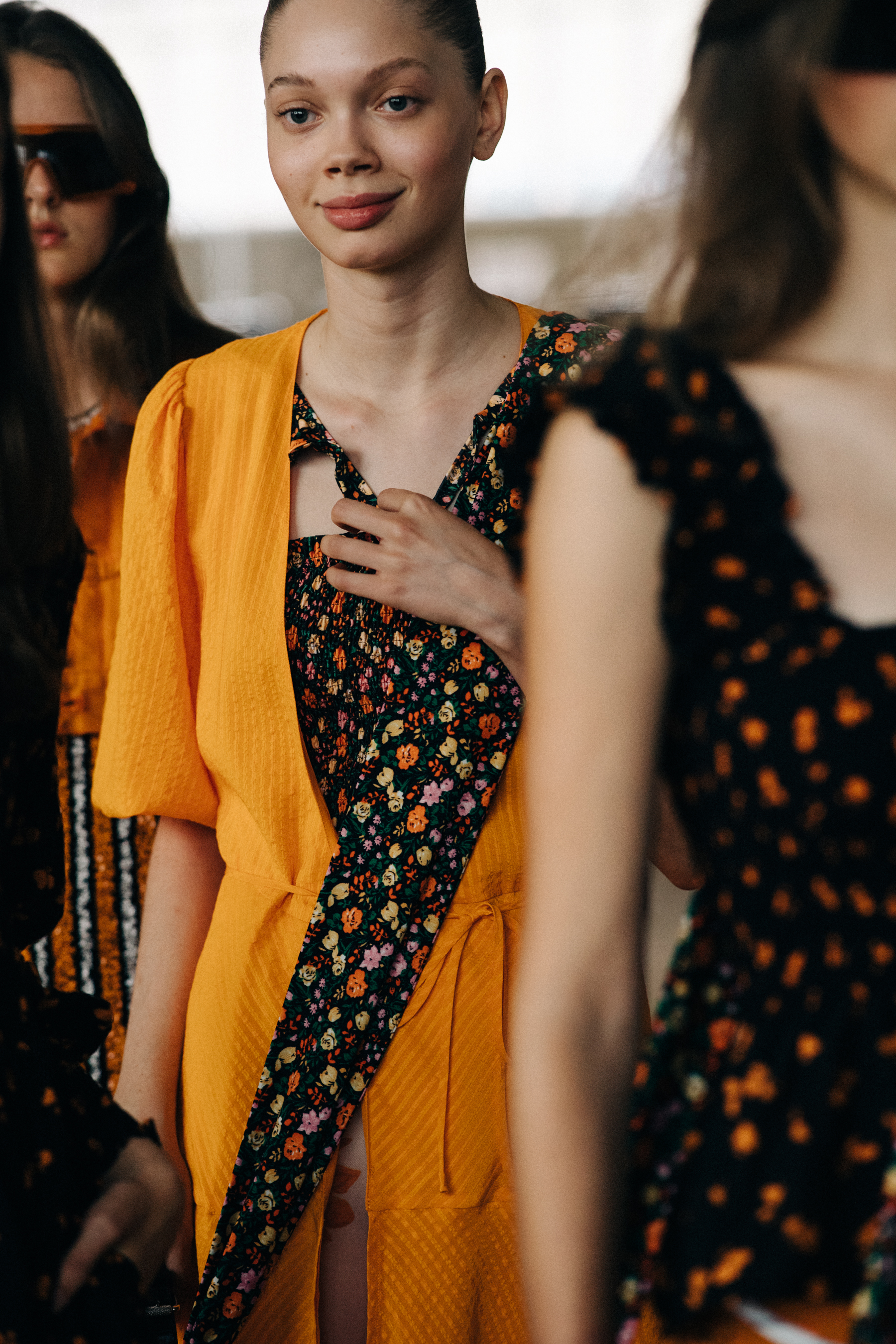 Model wearing orange outfit