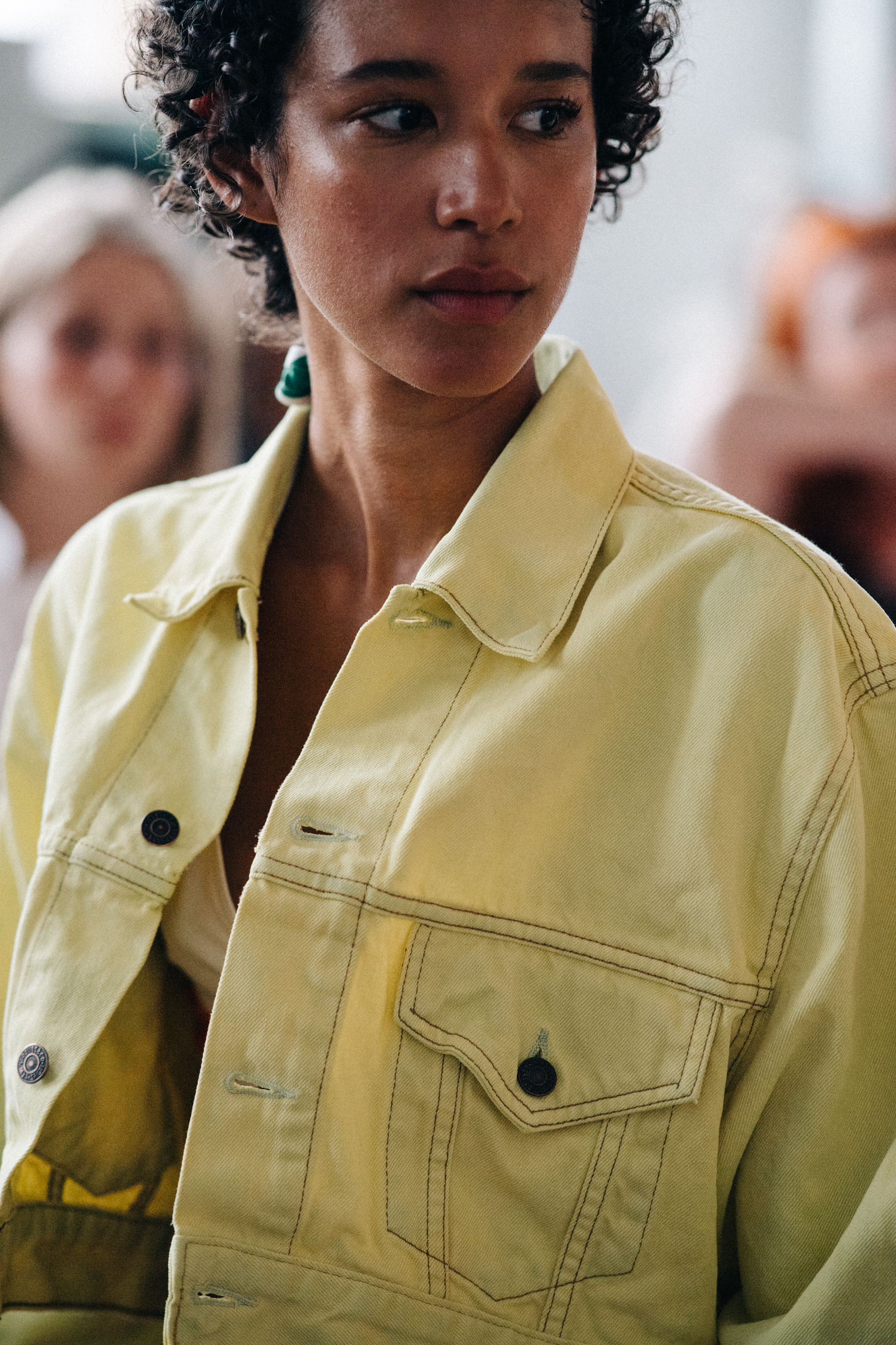 Model wearing yellow denim jacket