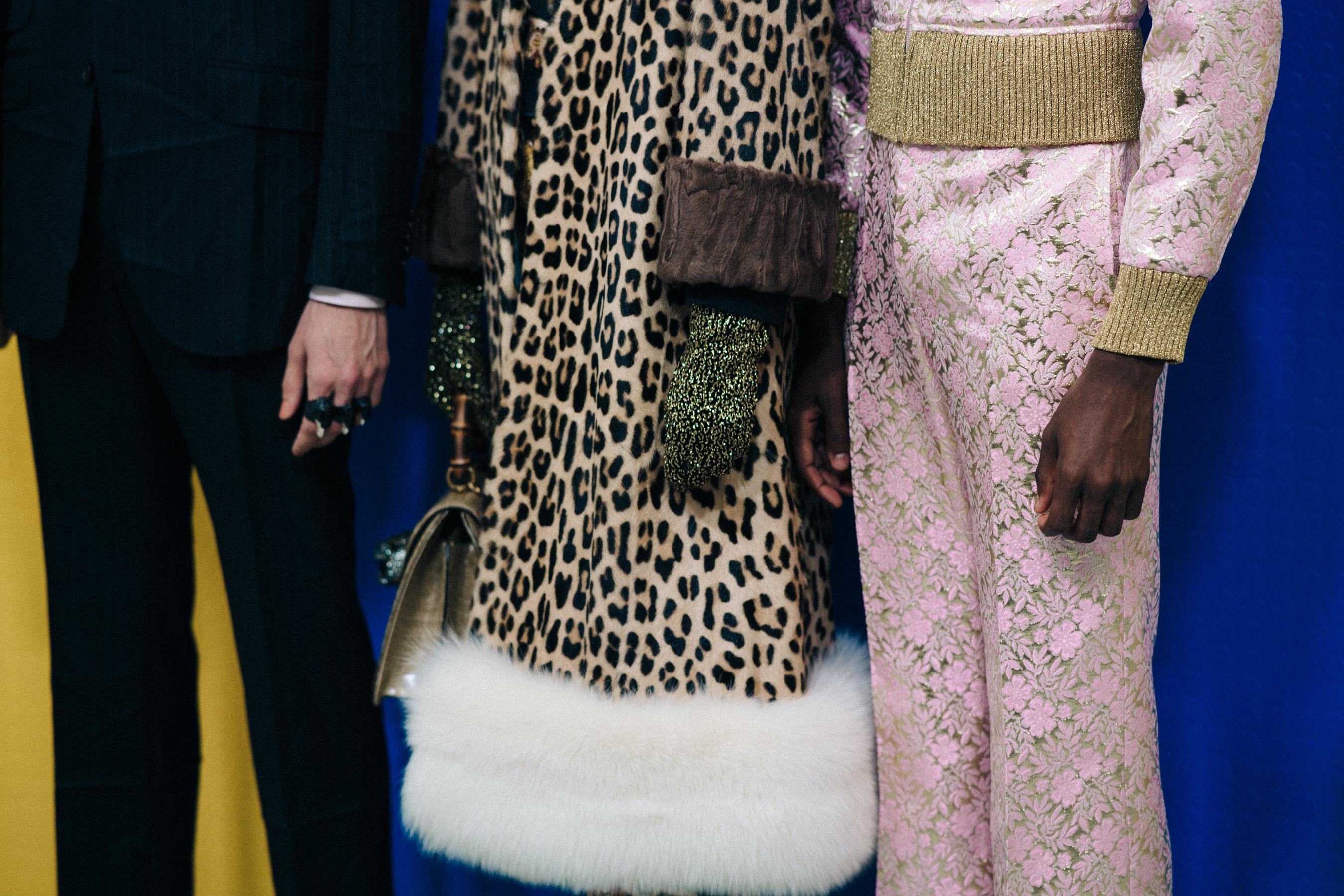 Detail of Gucci suit and bag on models