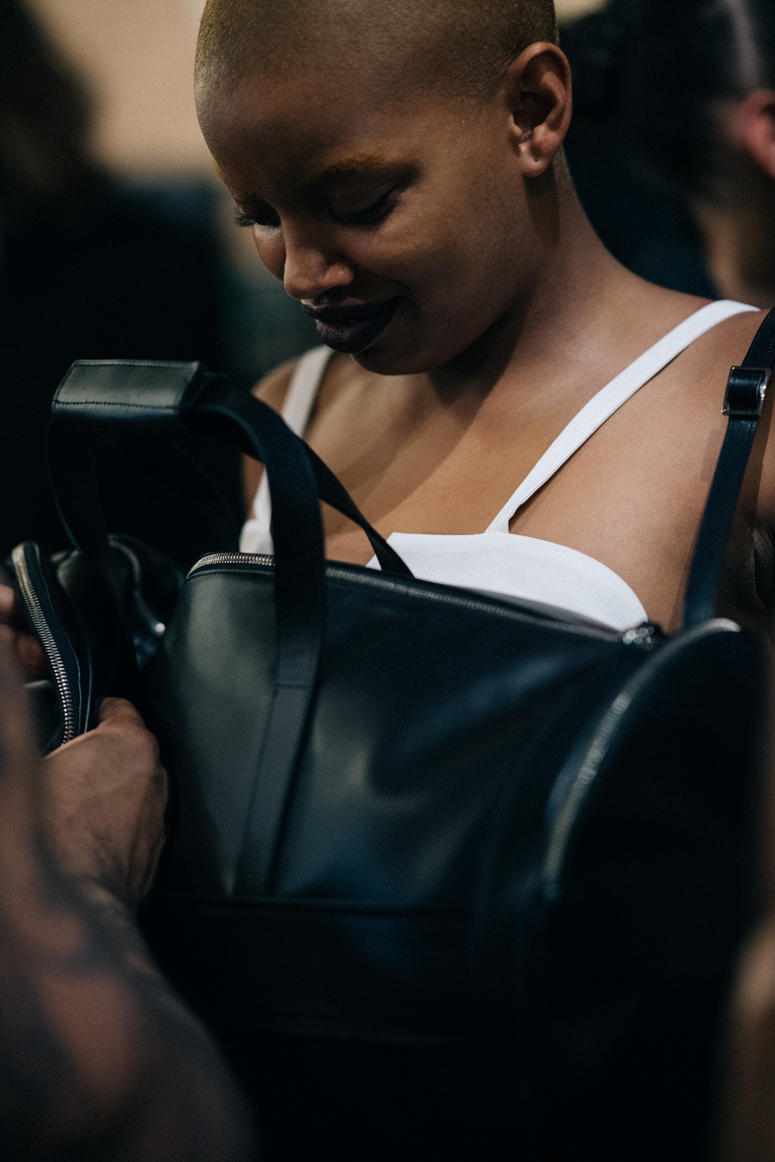 Model with teeth gap wearing black leather