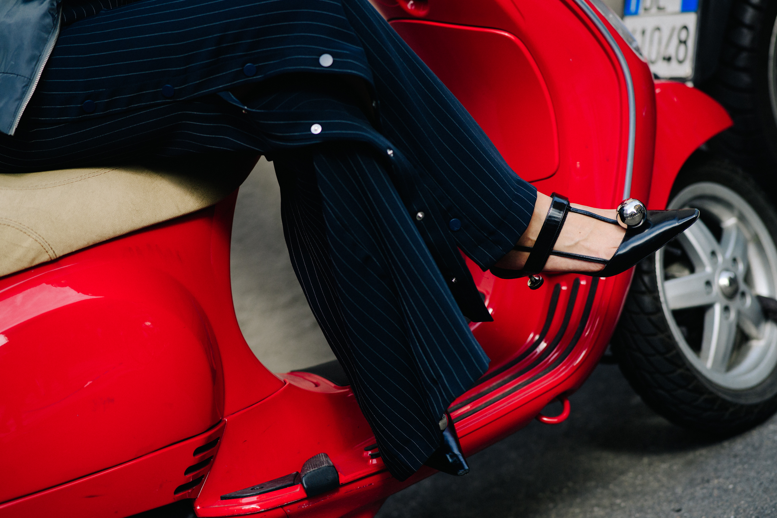 Closeup of woman wearing black heel and silver detail shoes