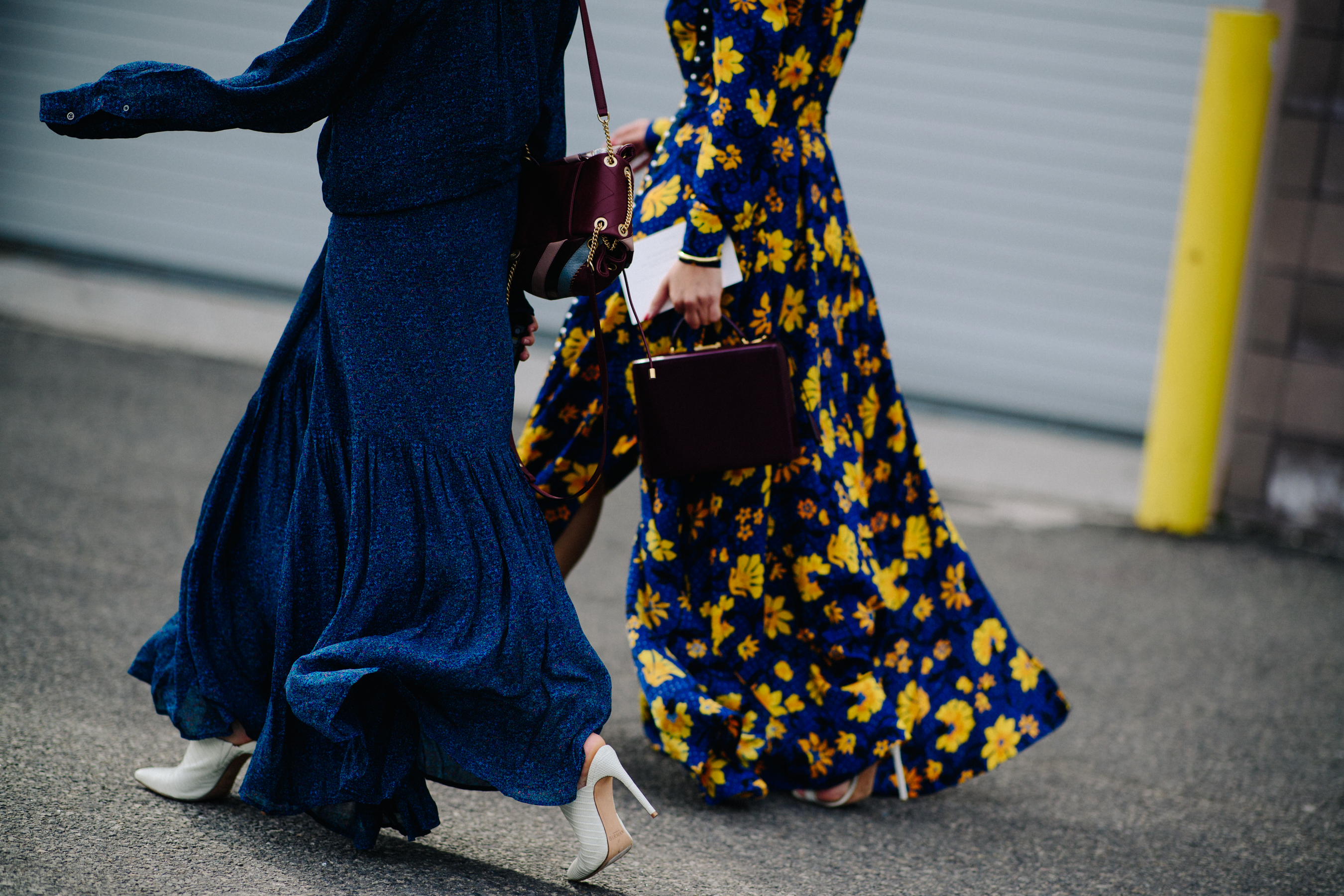 Two women wearing floral dresses