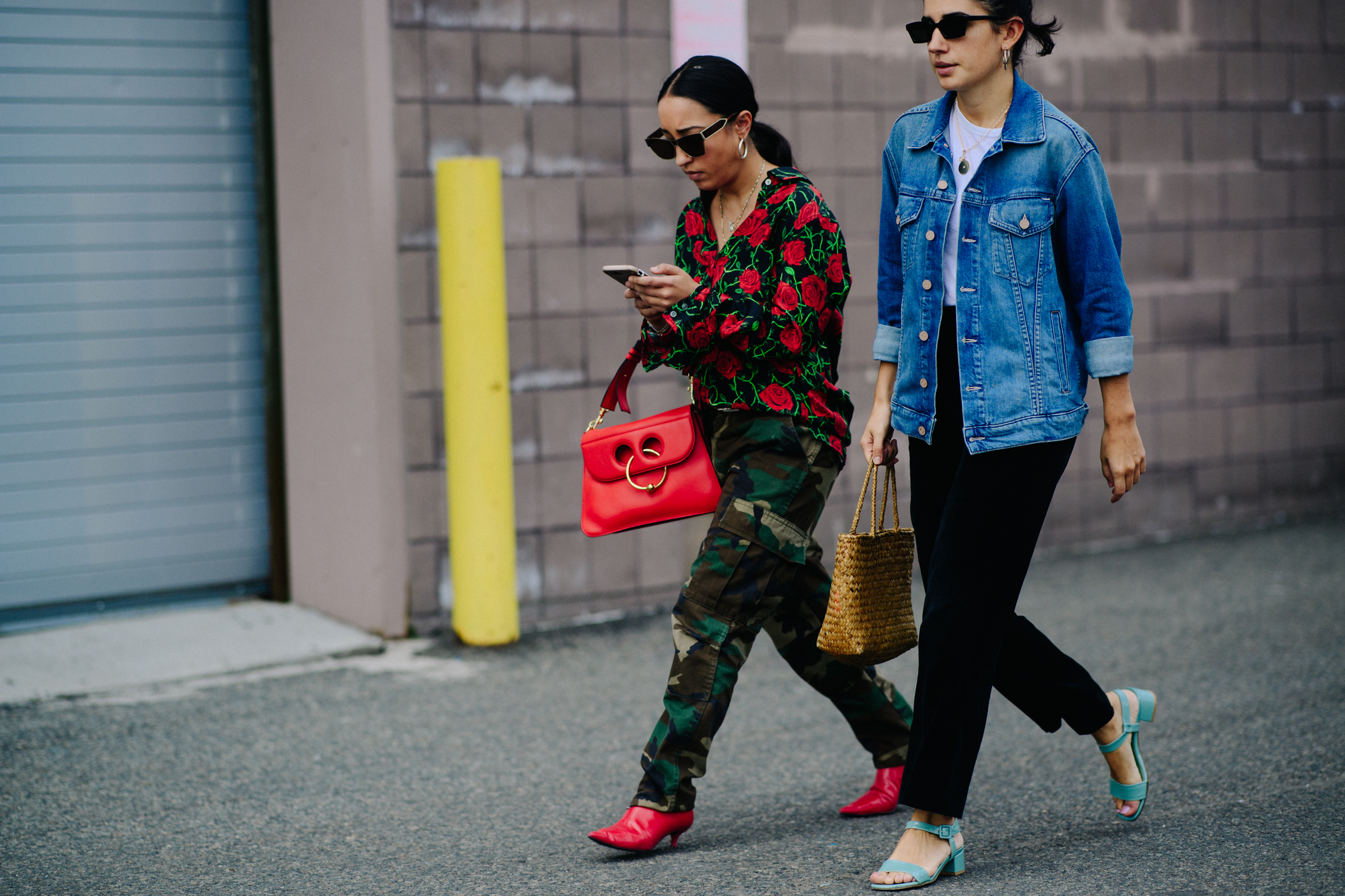 Two women wearing blue and red