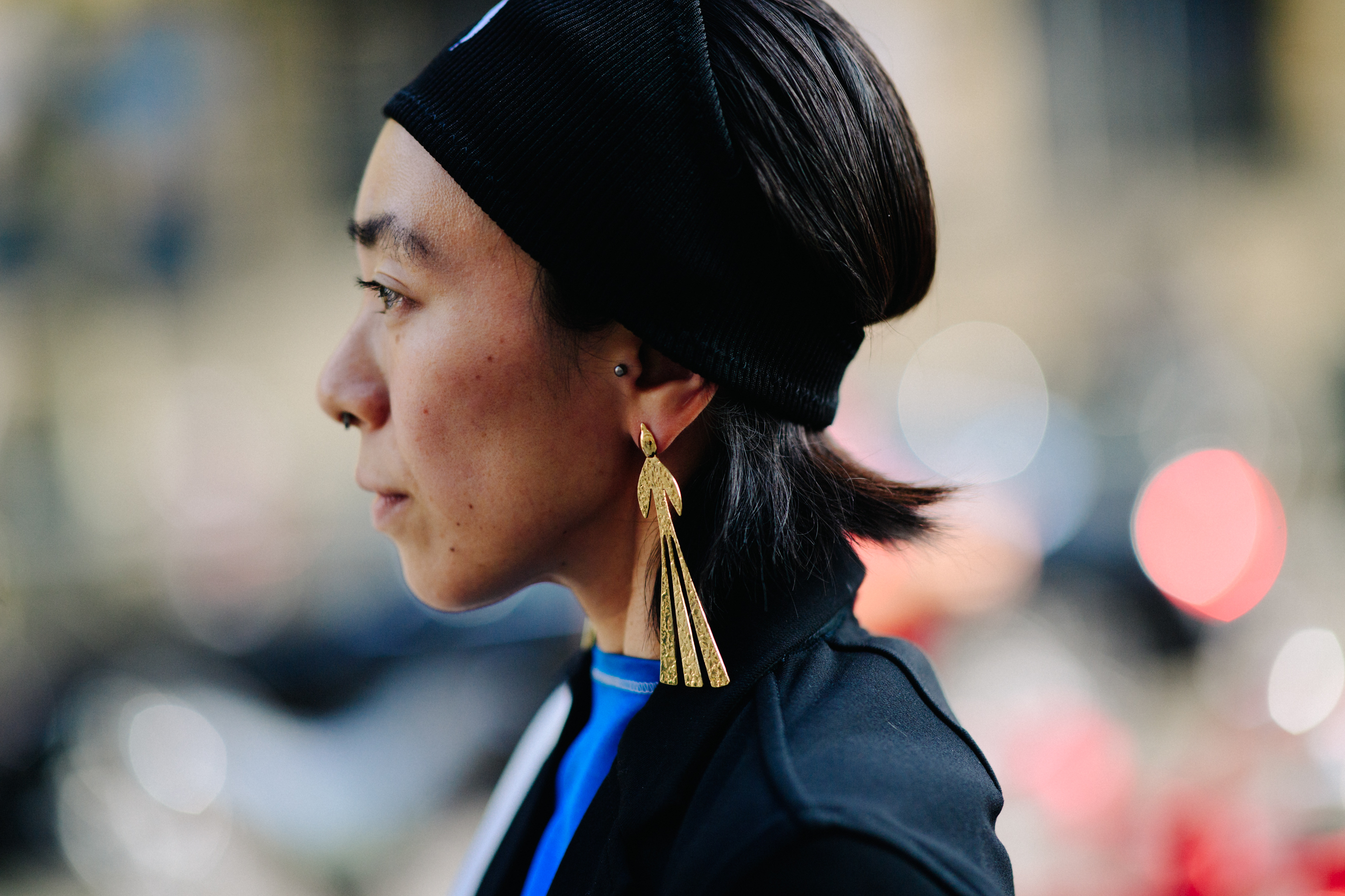 Woman wearing black hat and earrings