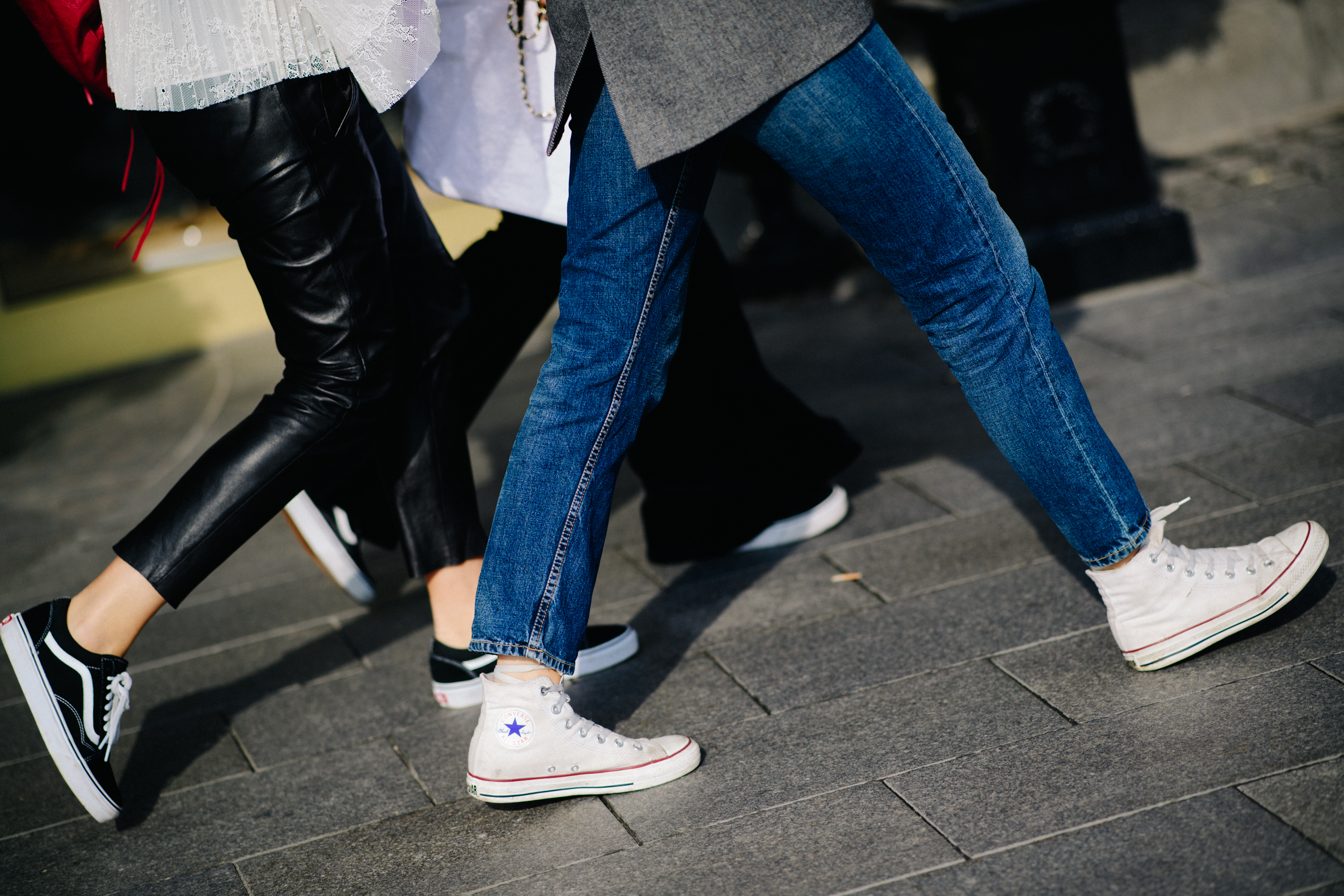 Women wearing Converse and Vans shoes