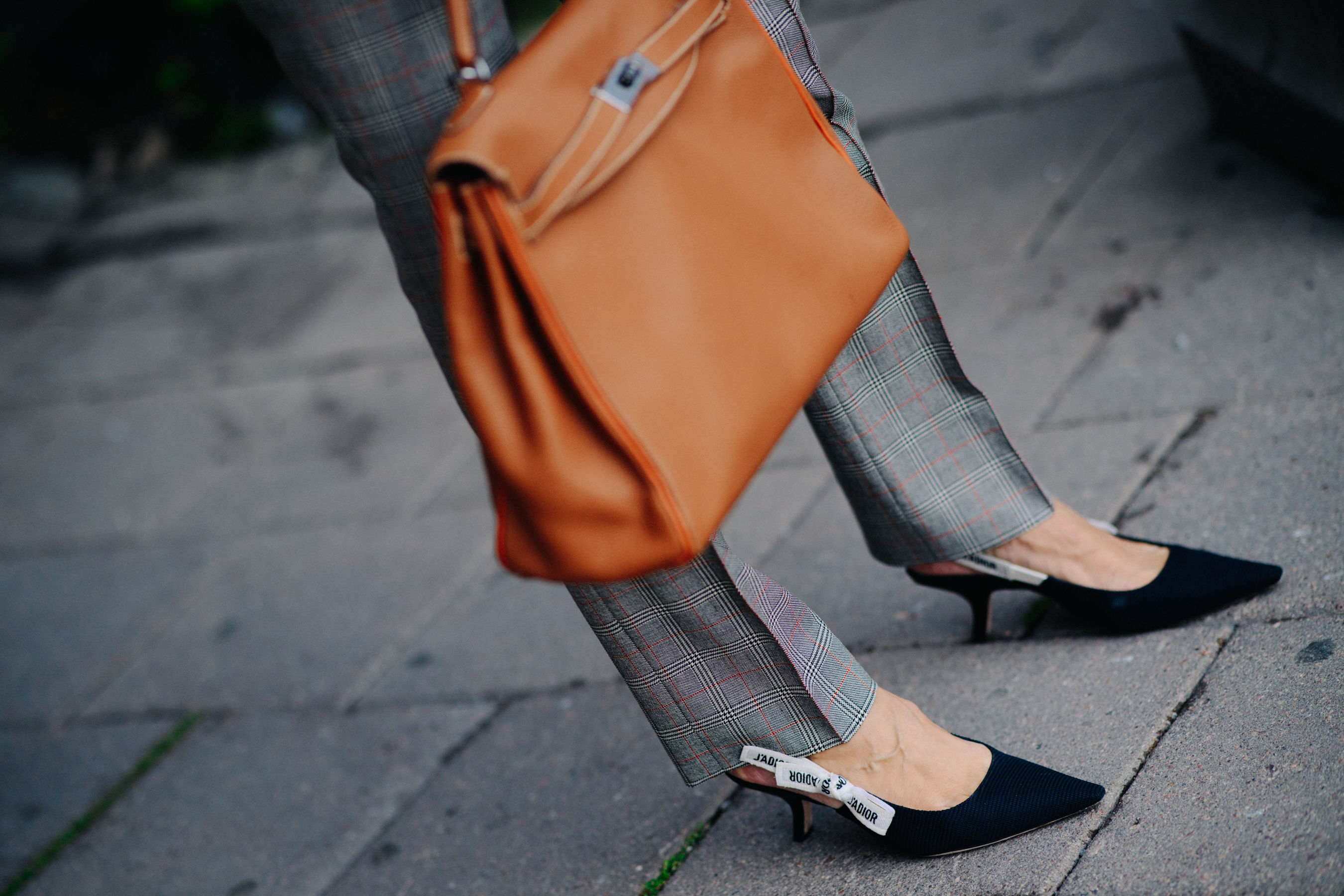 Woman wearing Dior kitten heel shoes