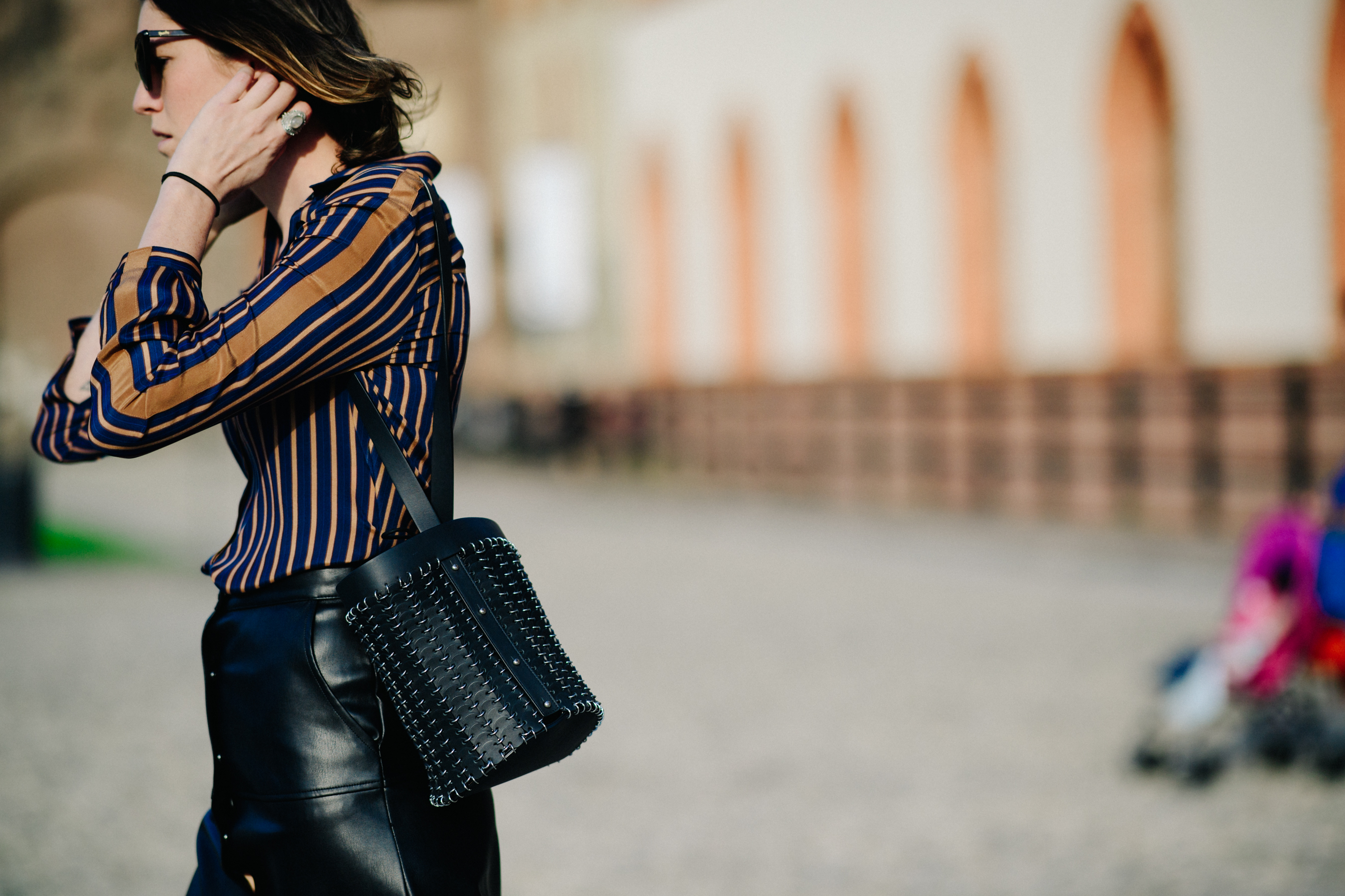 Woman brushing hair in striped shirt