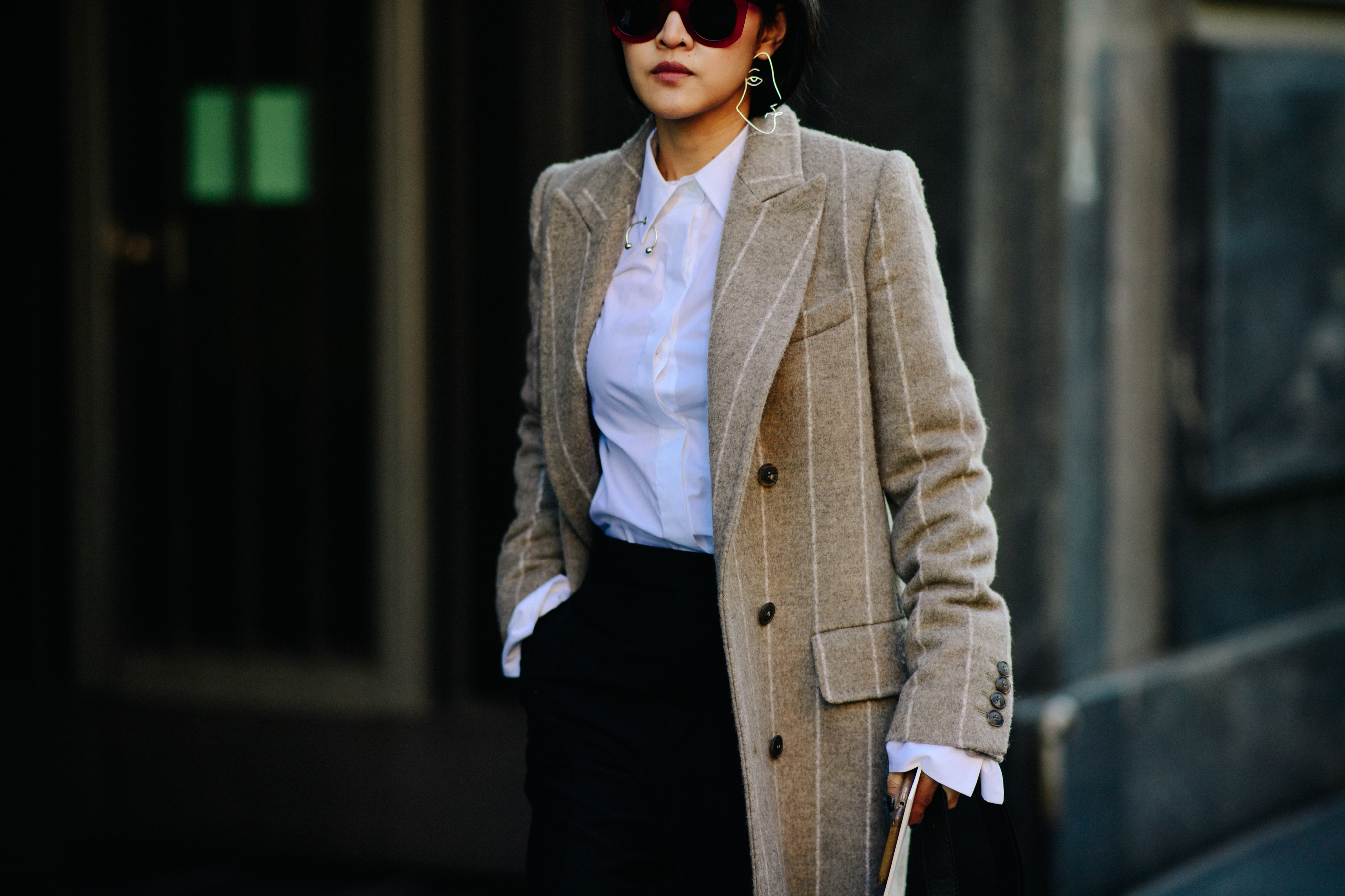 Woman wearing red glasses and white shirt