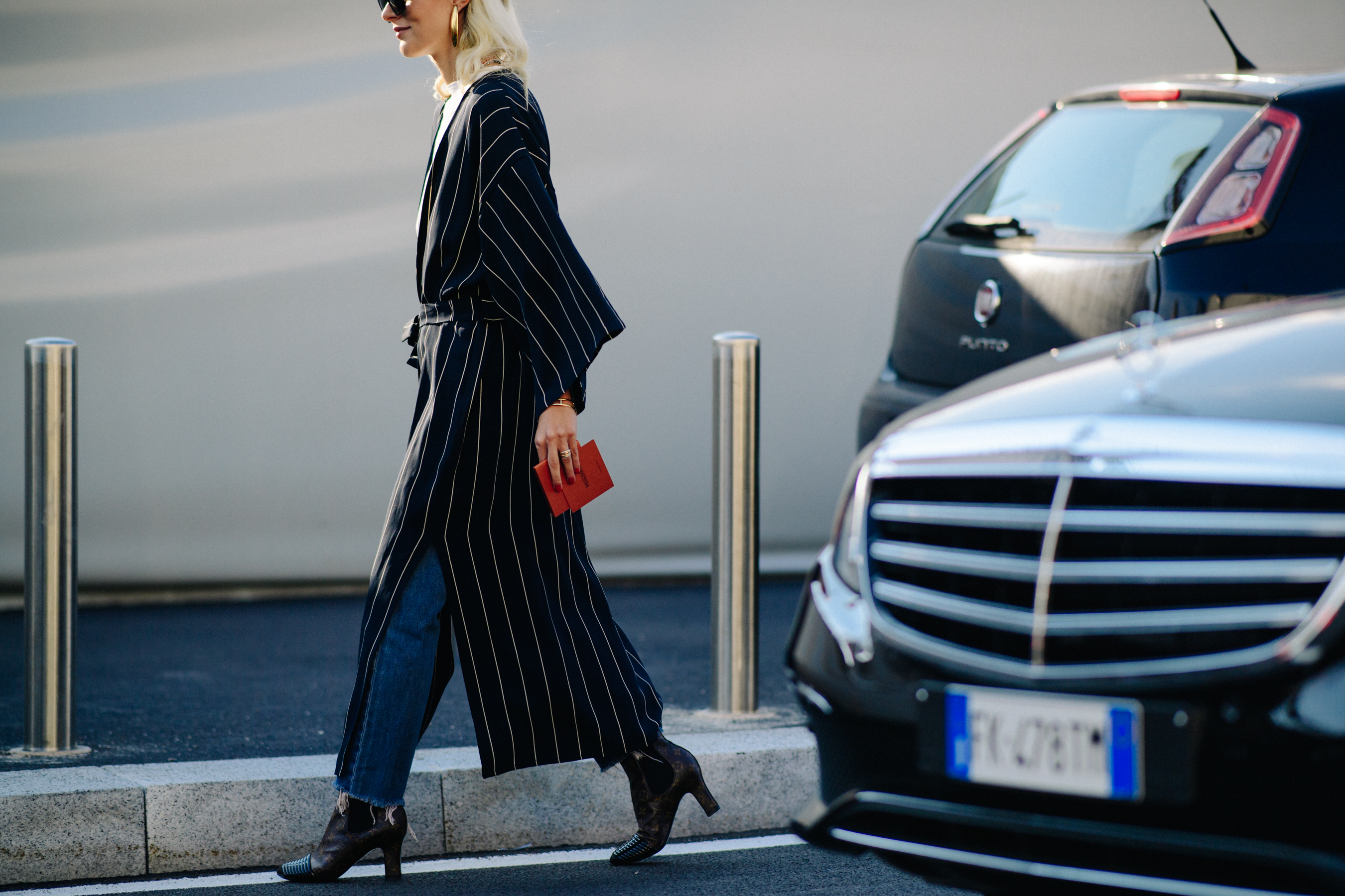 Woman wearing long balck and white striped coat