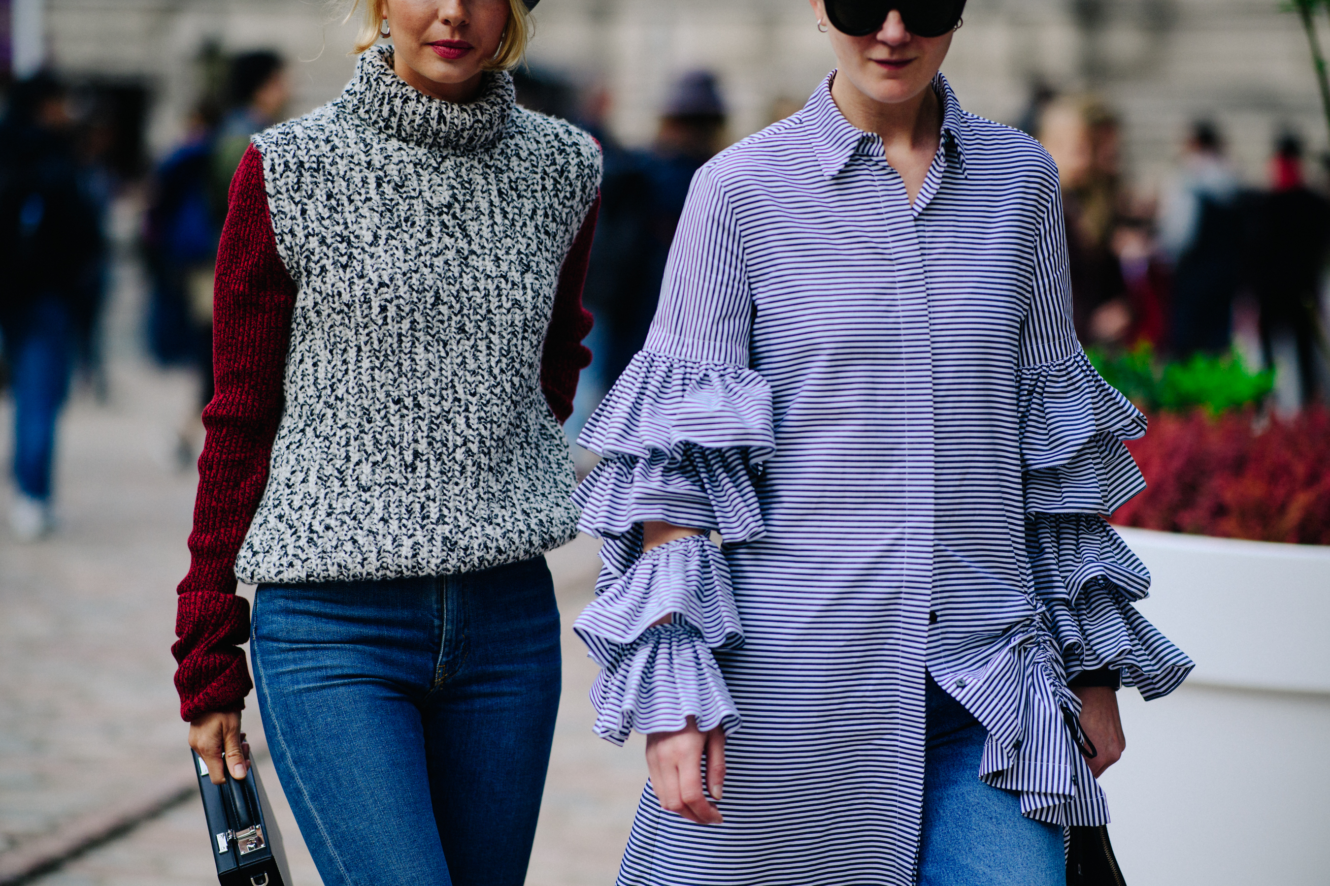 Two women wearing sweater and oversized shirt