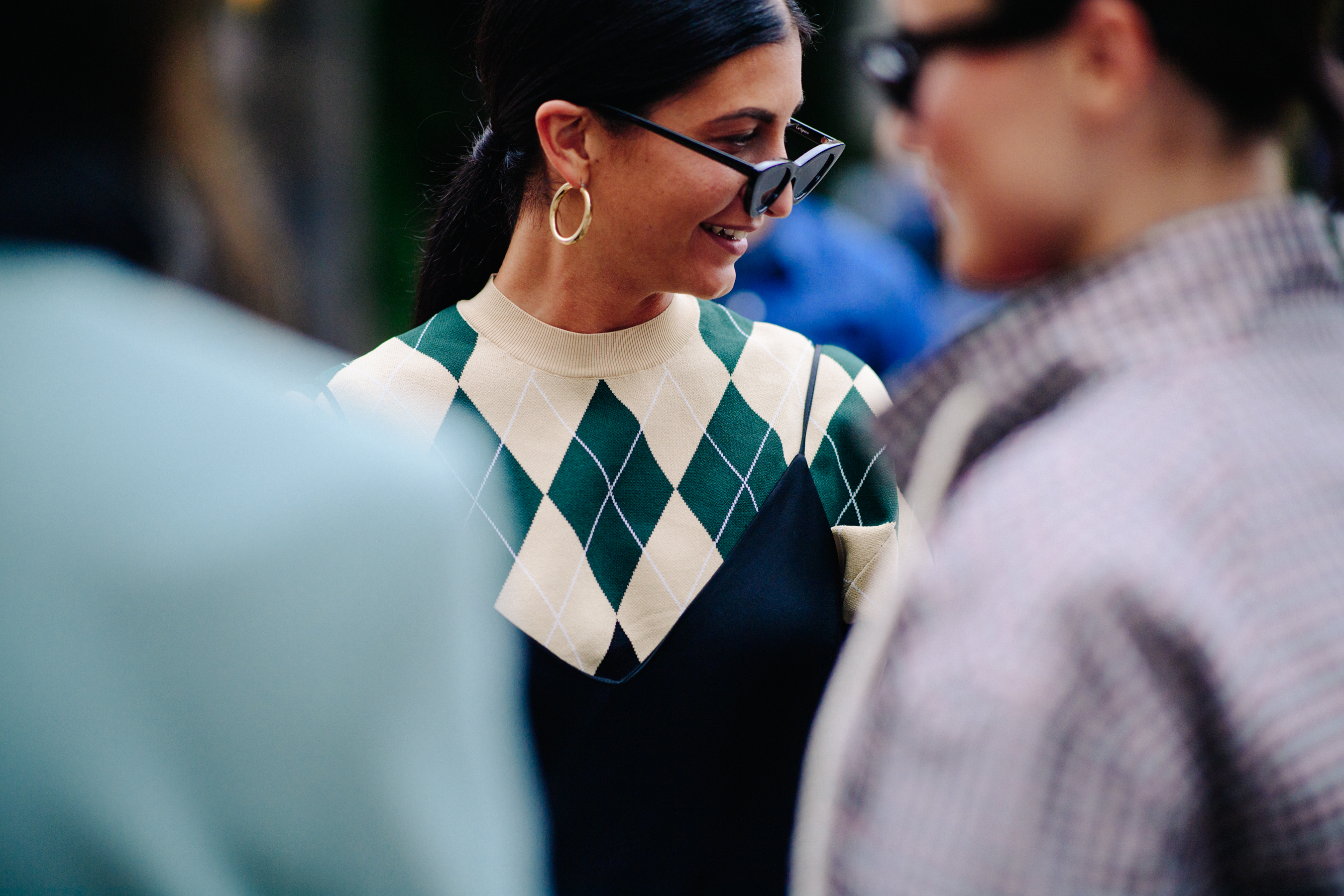 Woman wearing glasses and golden earrings