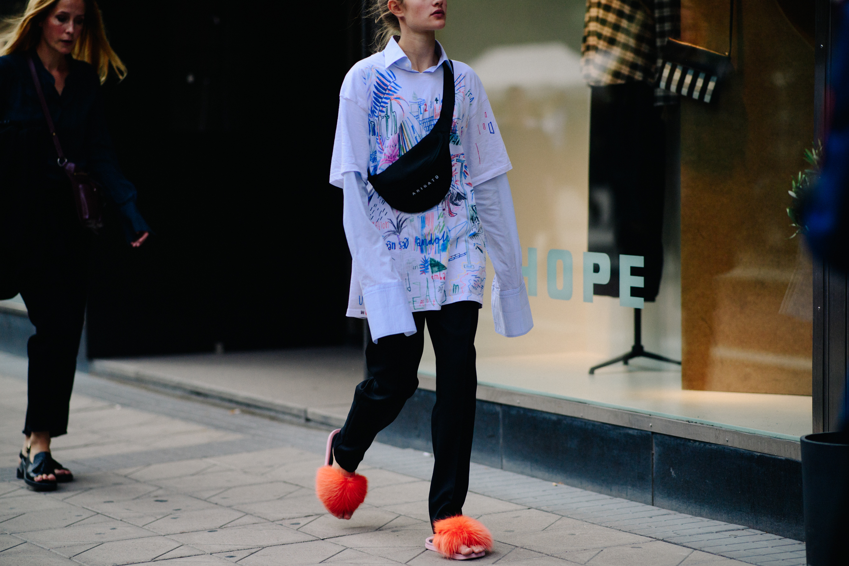 Woman wearing furry slippers and shirt
