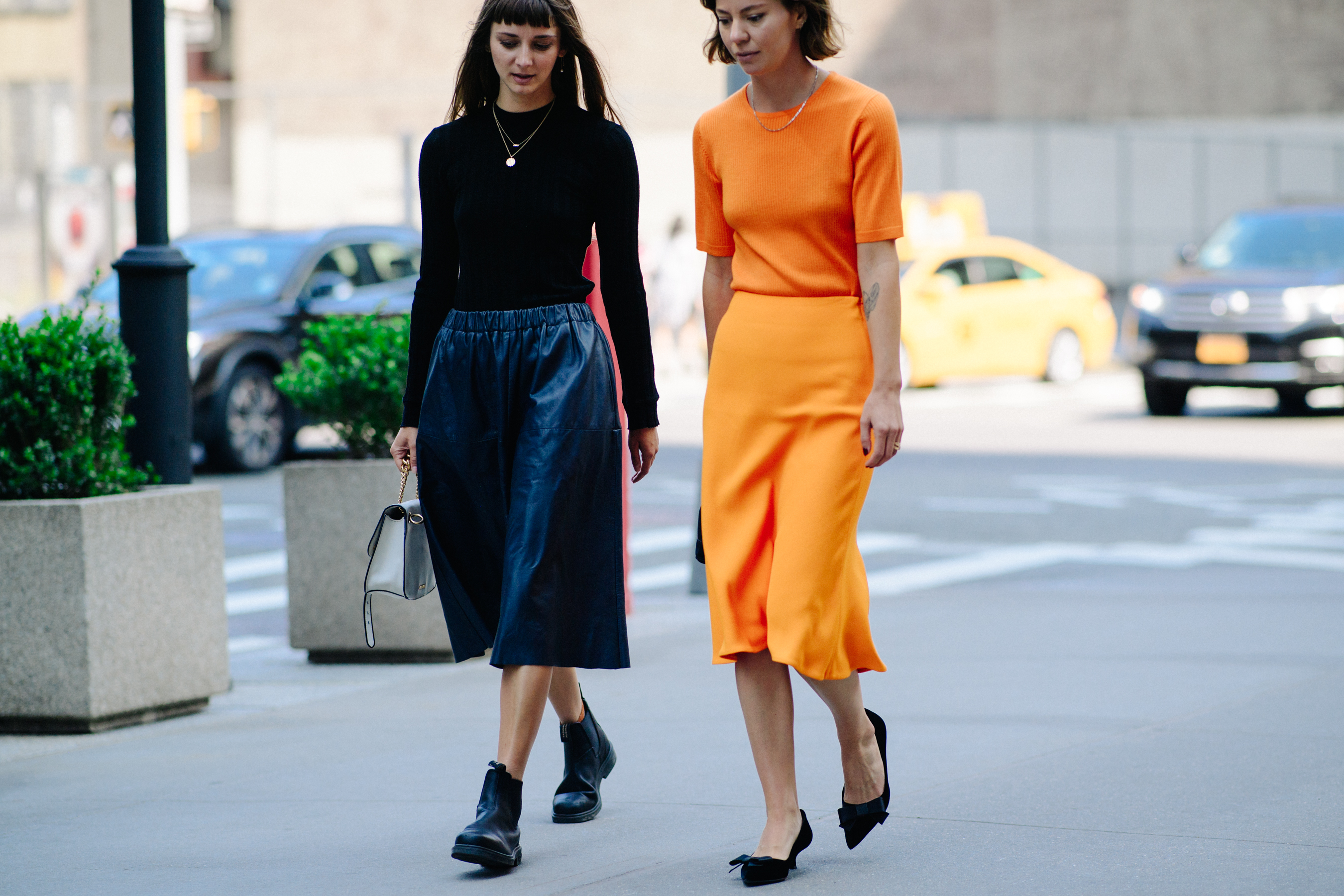 Two women wearing black and orange