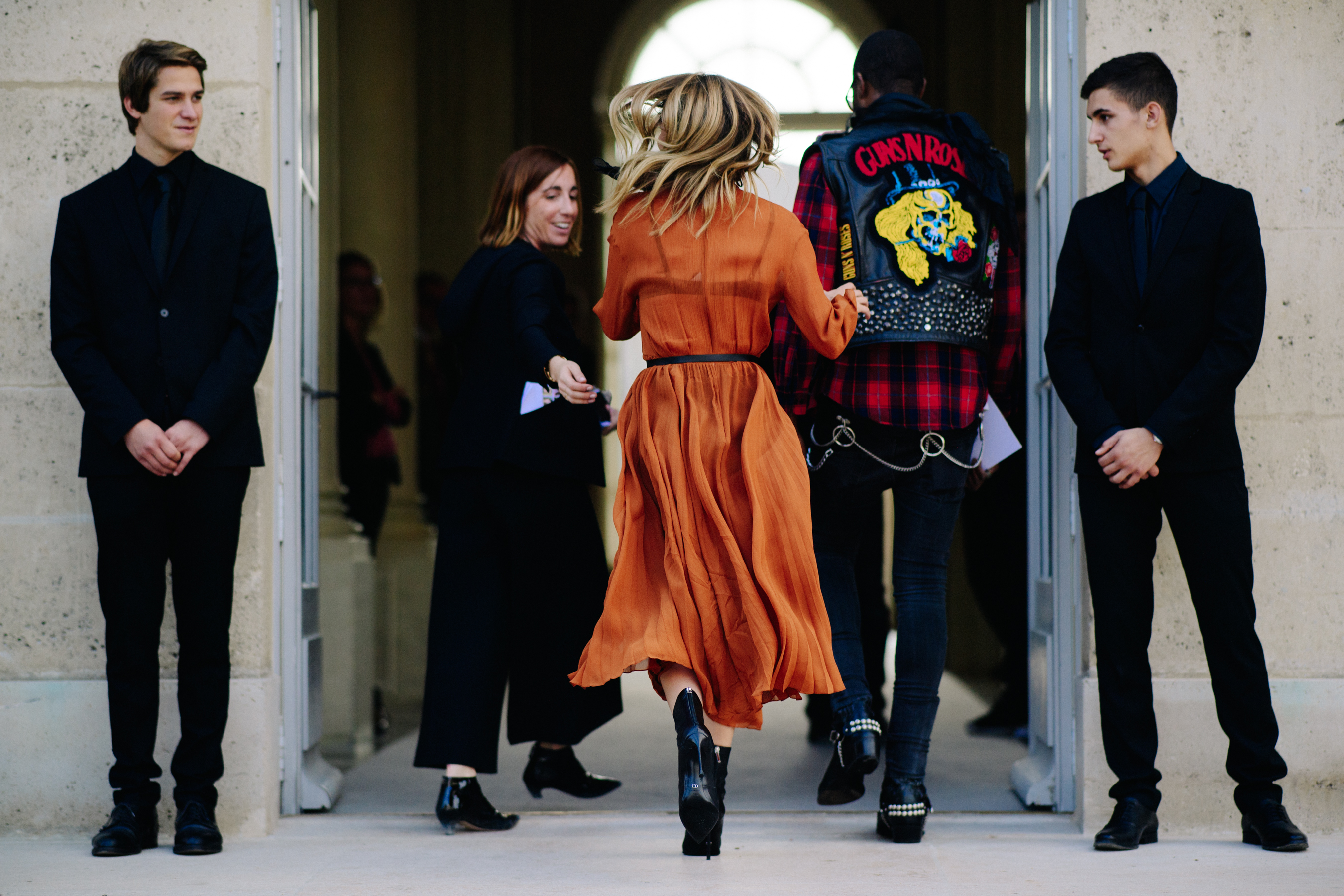 Woman wearing orange Christian Dior outfit