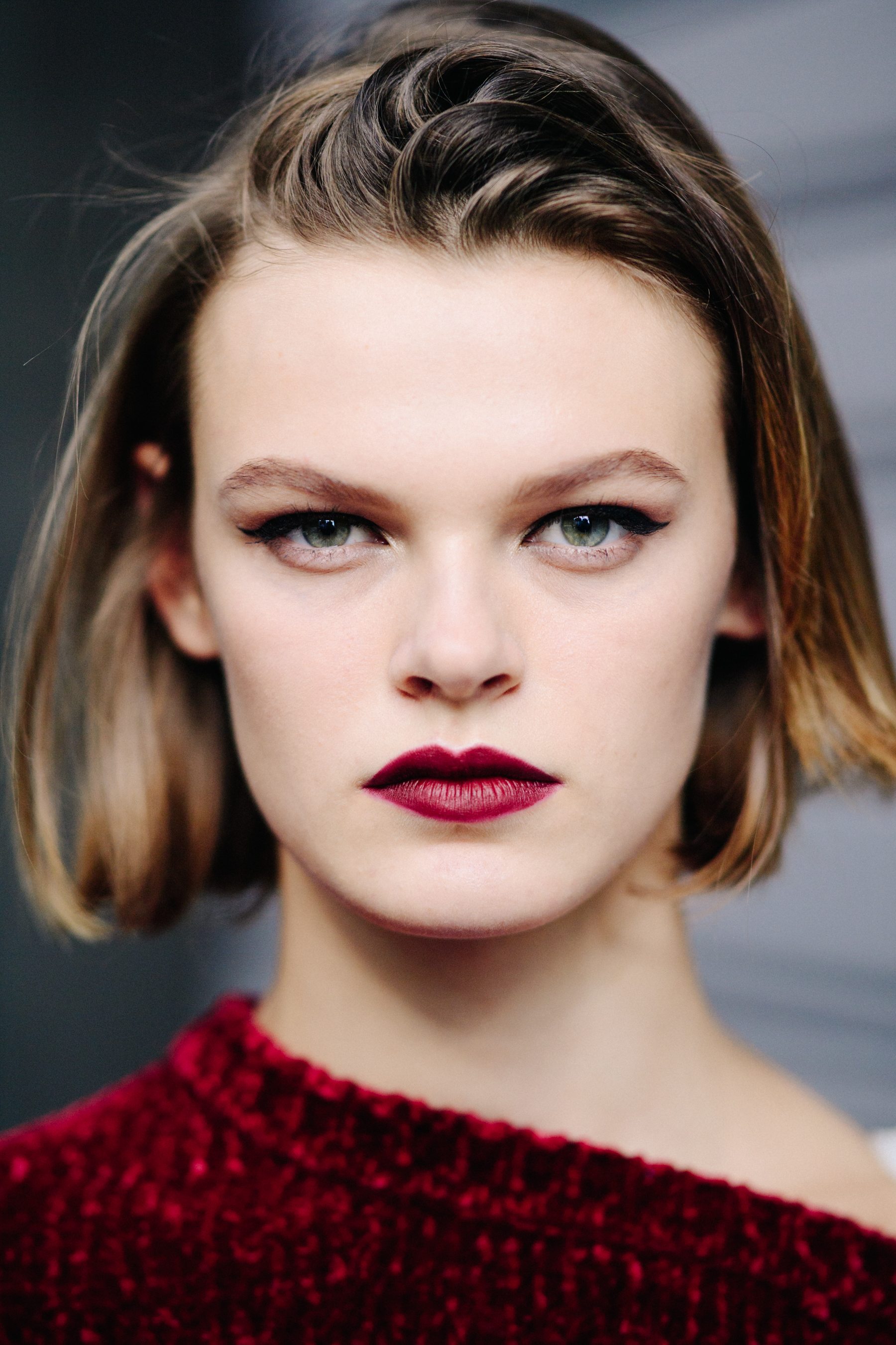Portrait of a model with red lips after the show