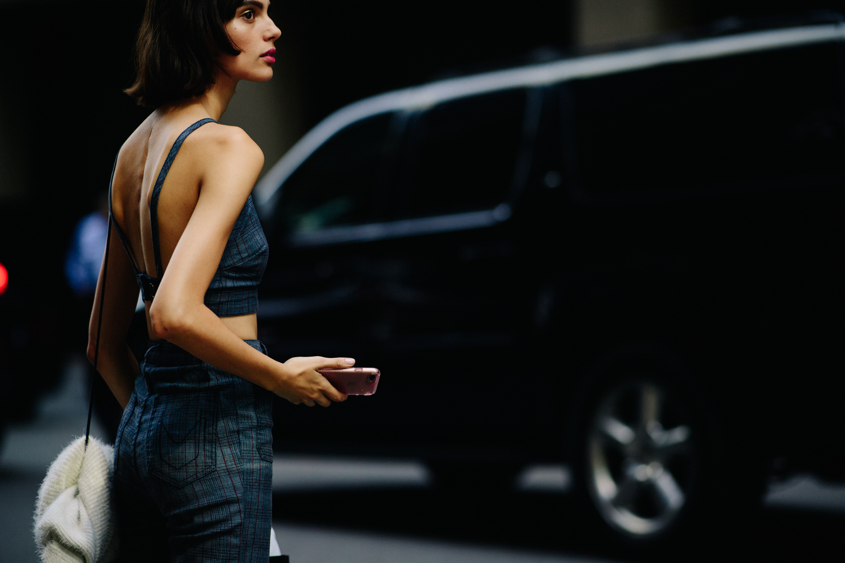 Model wearing jeans and white bag