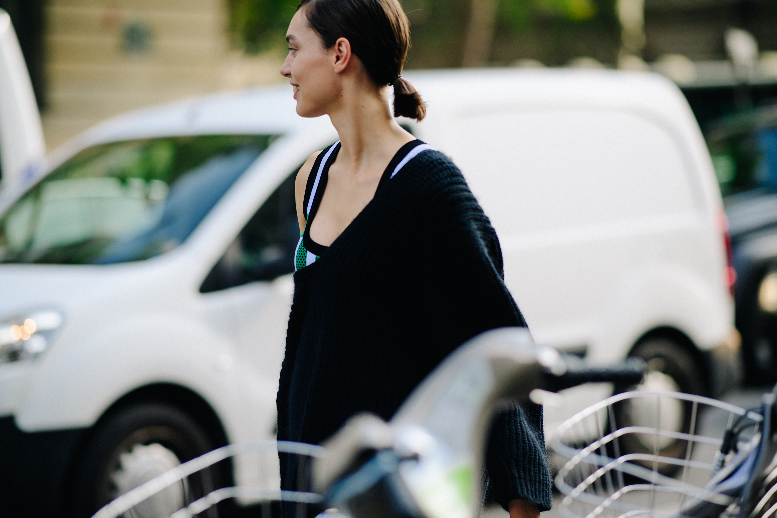 Model wearing black poncho after a show