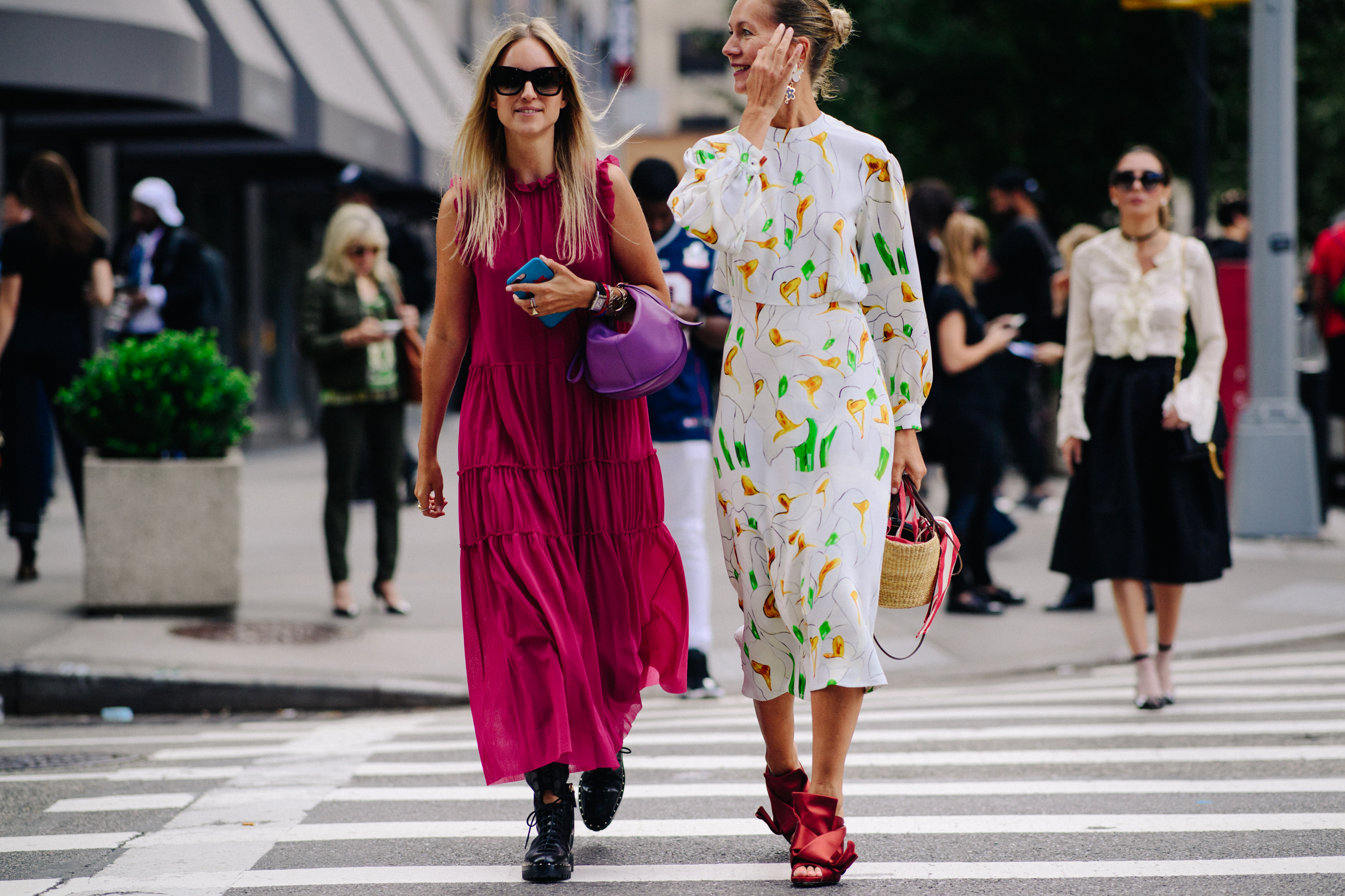 Two women wearing long dresses
