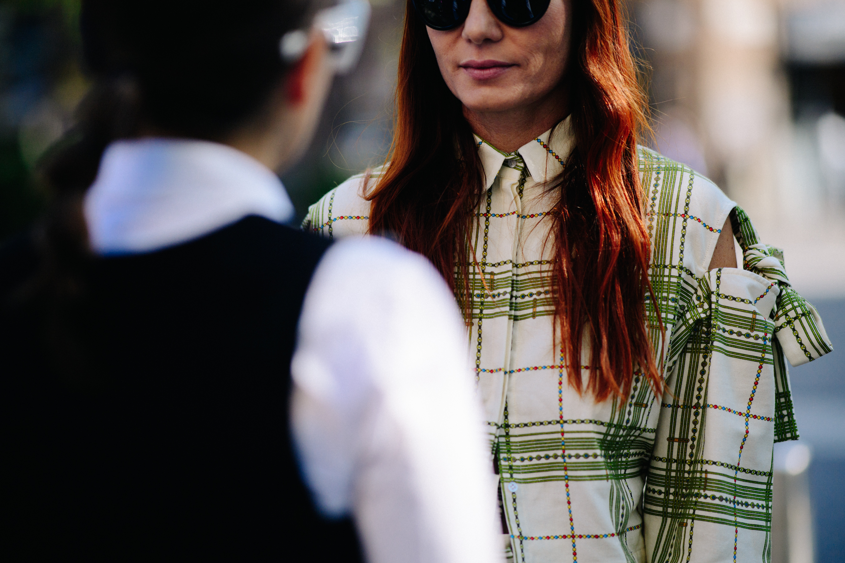 Woman with long red hair wearing shirt