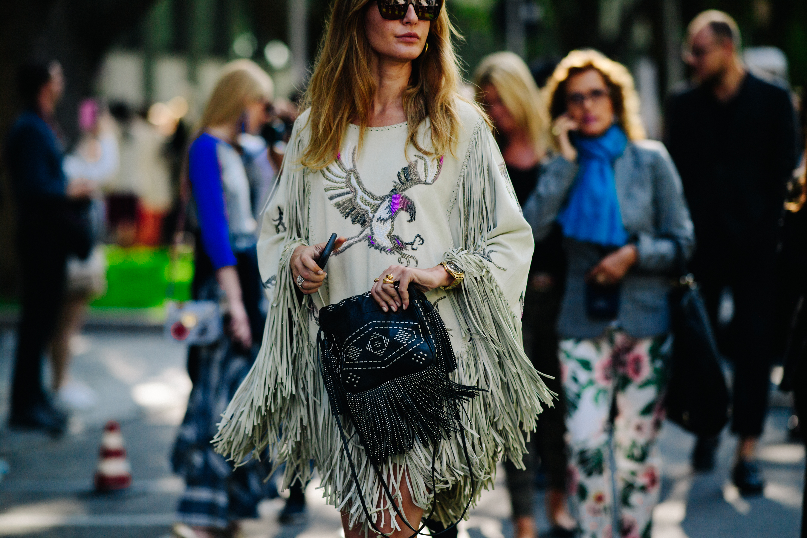 Woman wearing green tasselled top