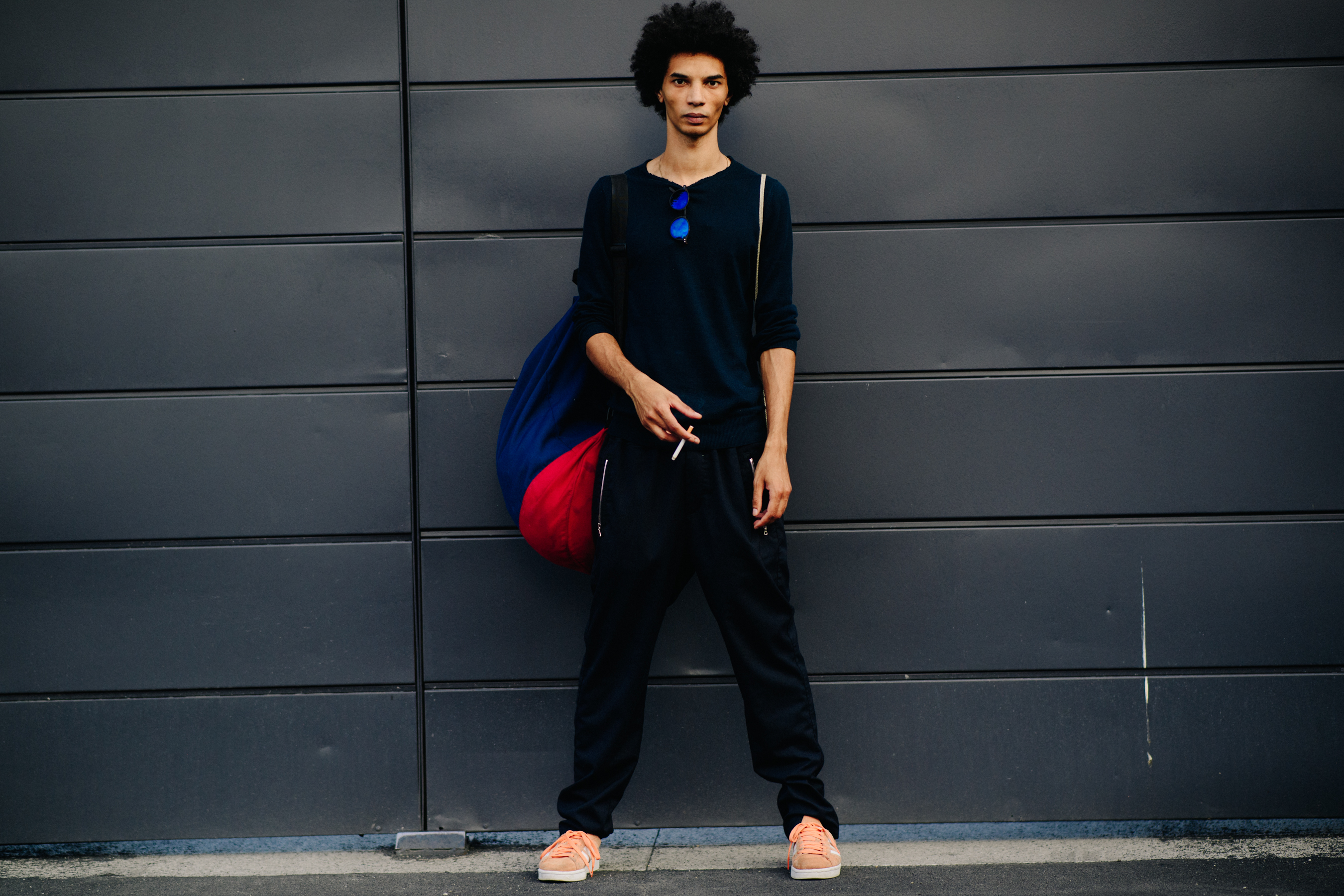 Male model smoking in dark clothes