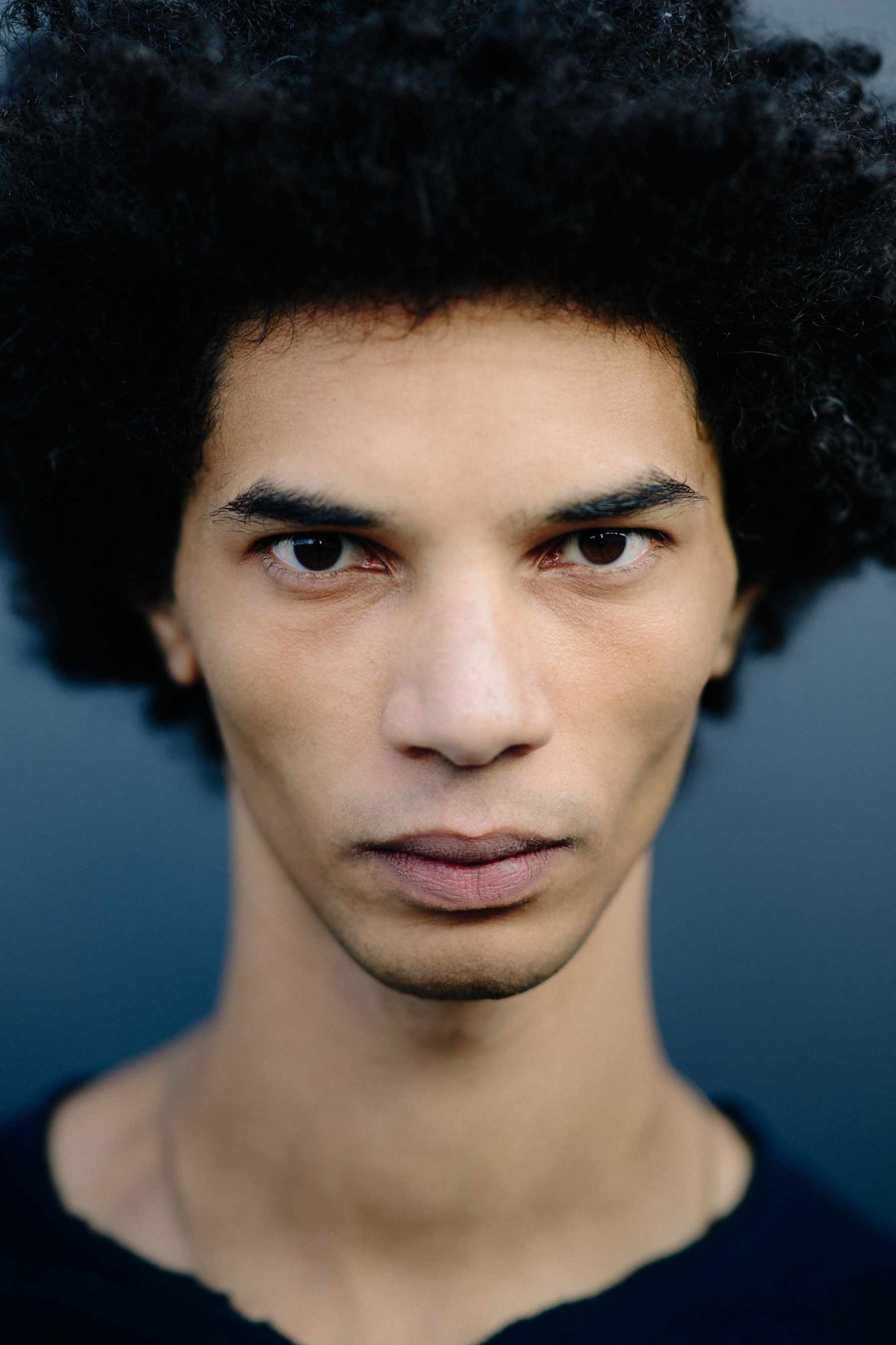 Portrait of male model with black curly hair