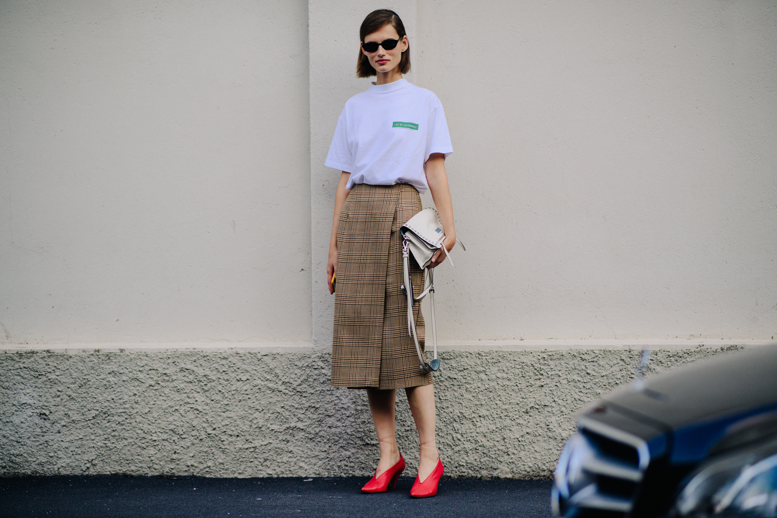 Model standing in white tee shirt and long check skirt
