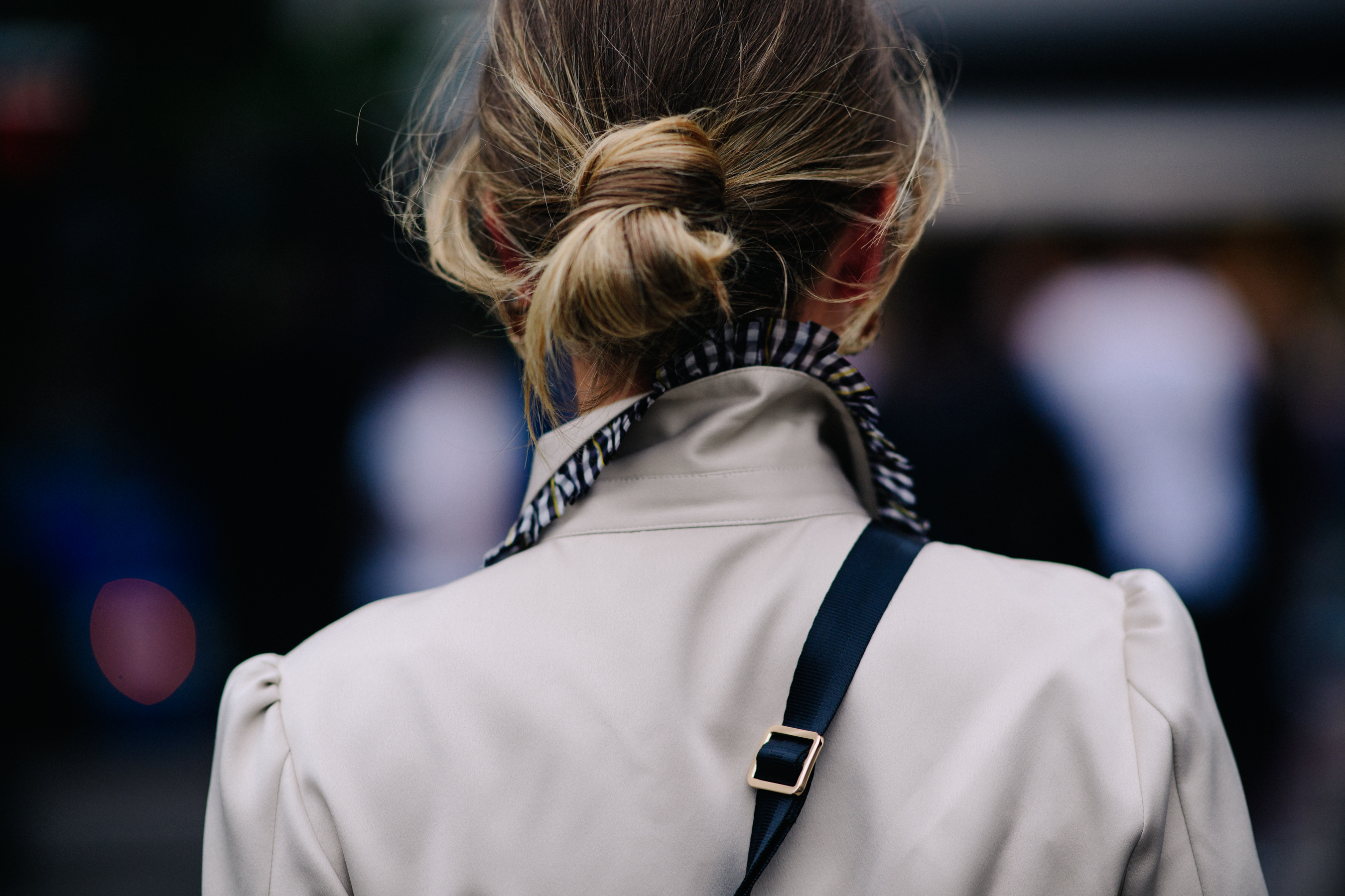 Woman wearing coat with ruffled collar