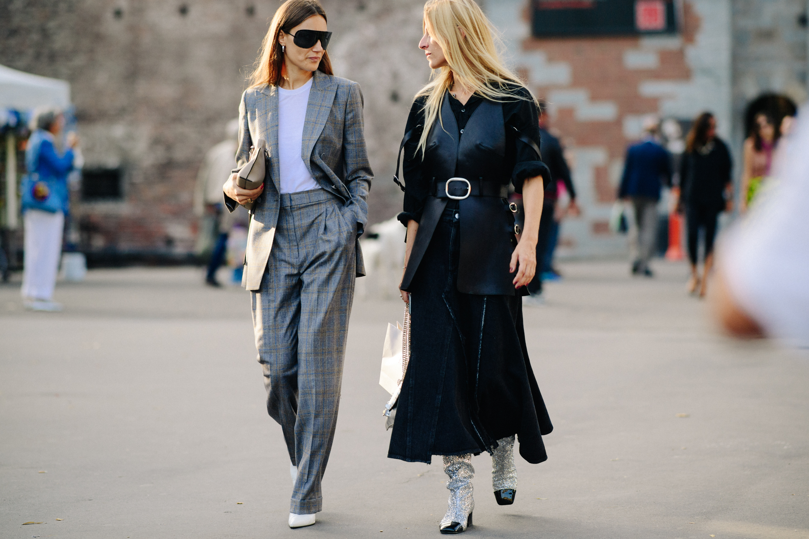 Two women walking in formal outfits