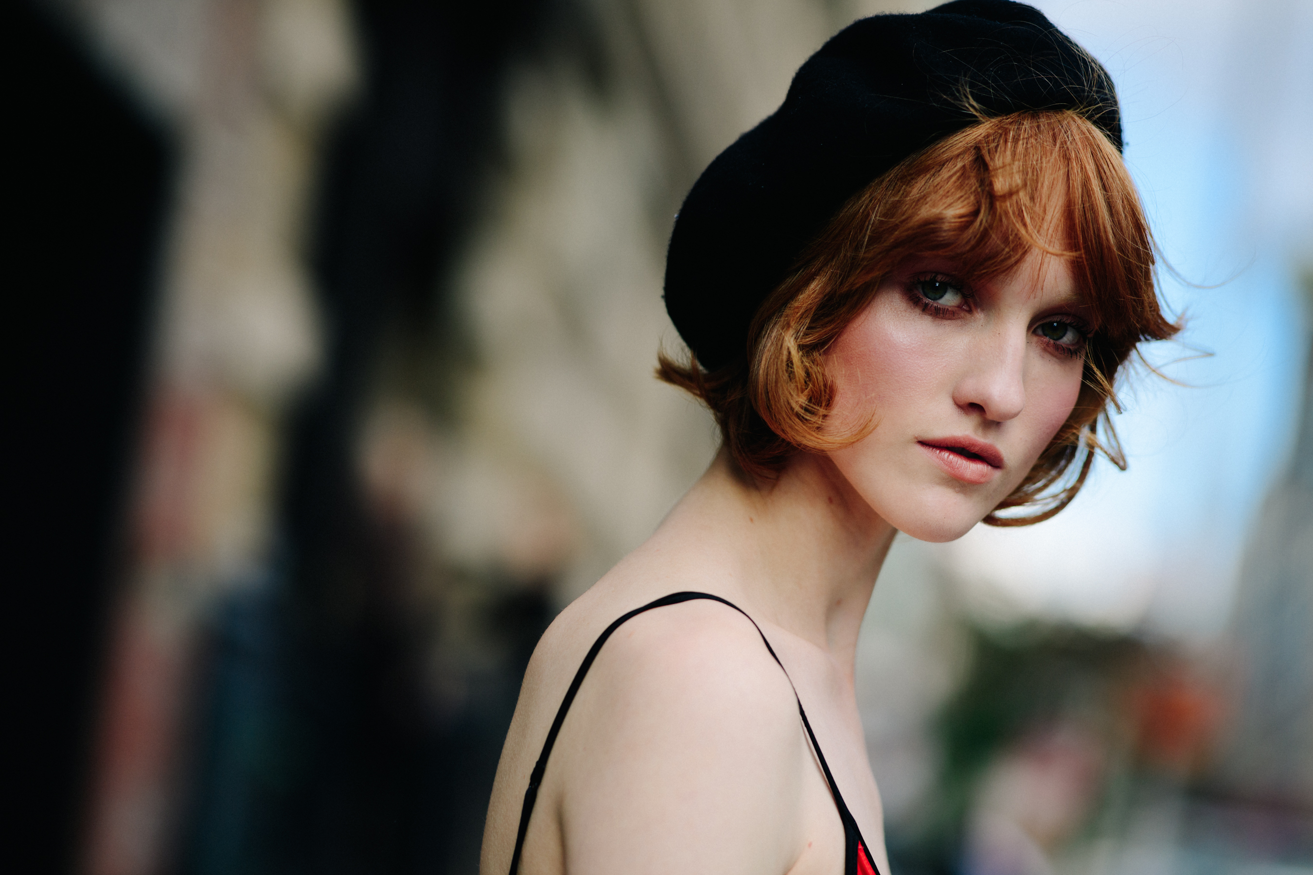 Model with red hair wearing beret and top