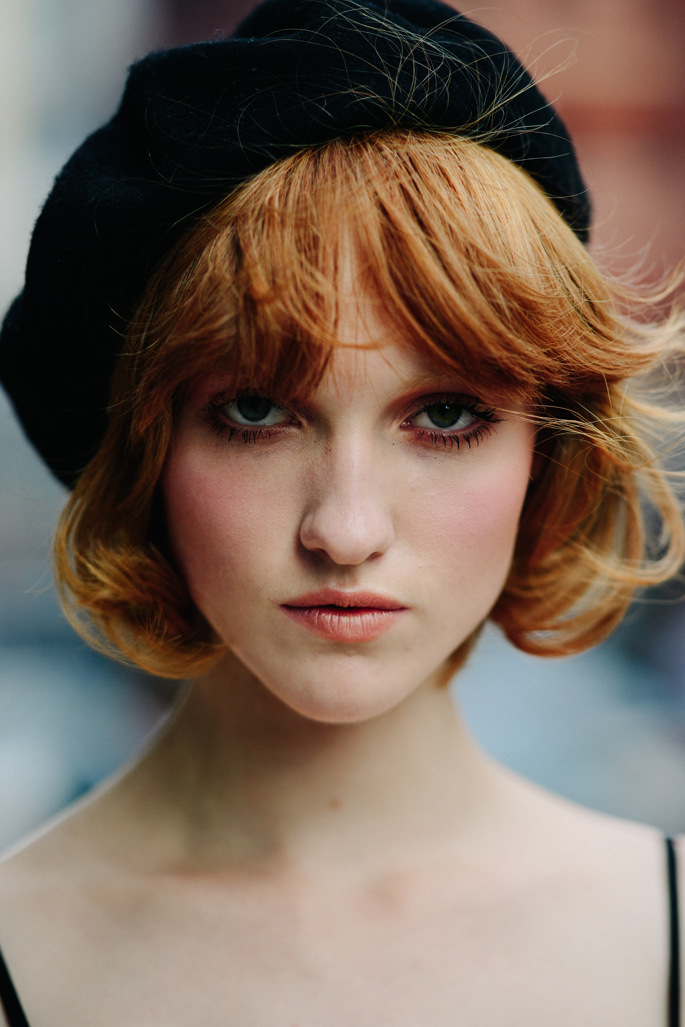 Model with red hair wearing beret and top