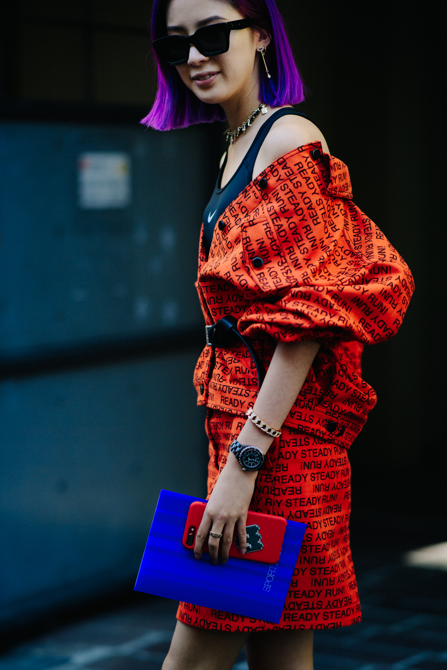 Model wearing red graphic text outfit