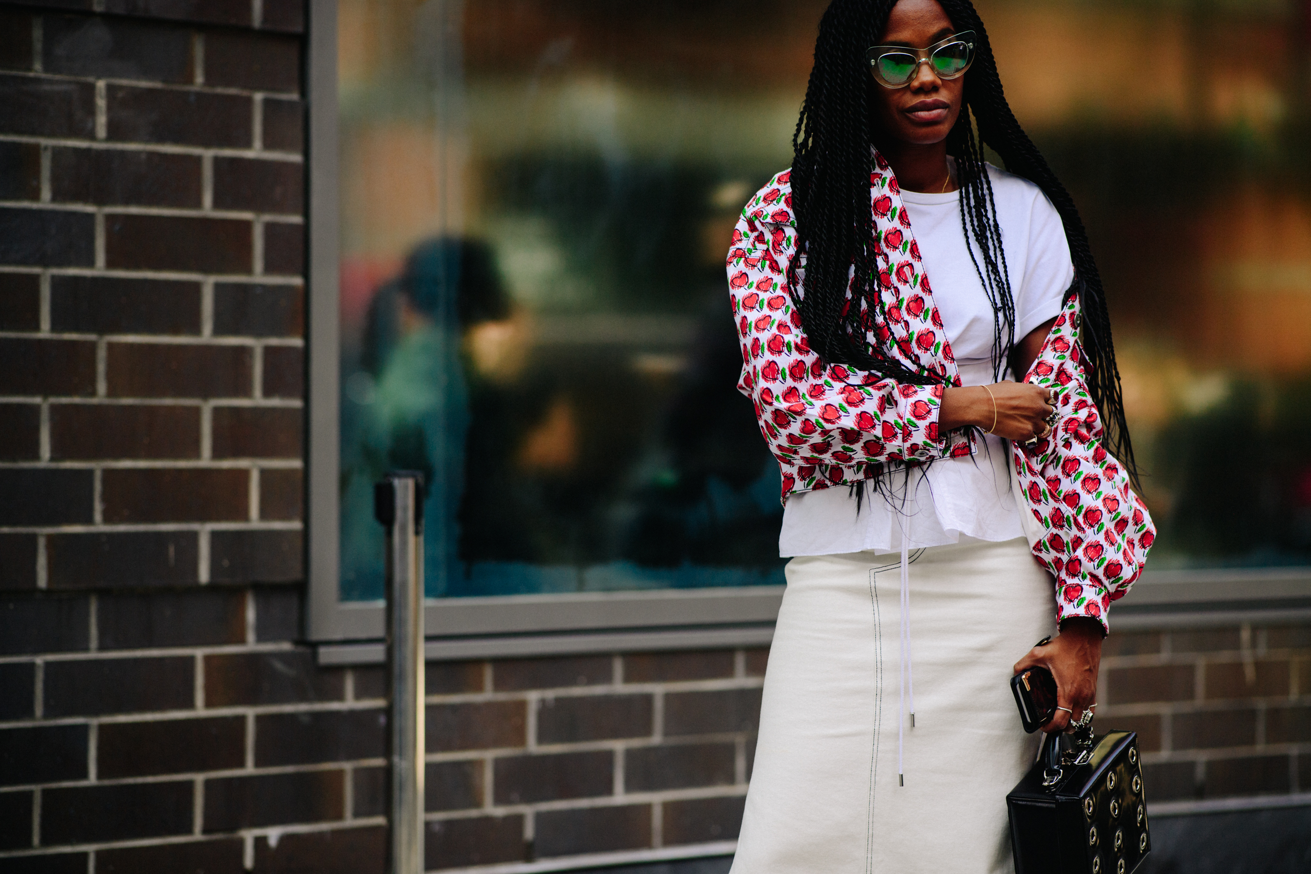 Woman wearing red bomber and sunglasses