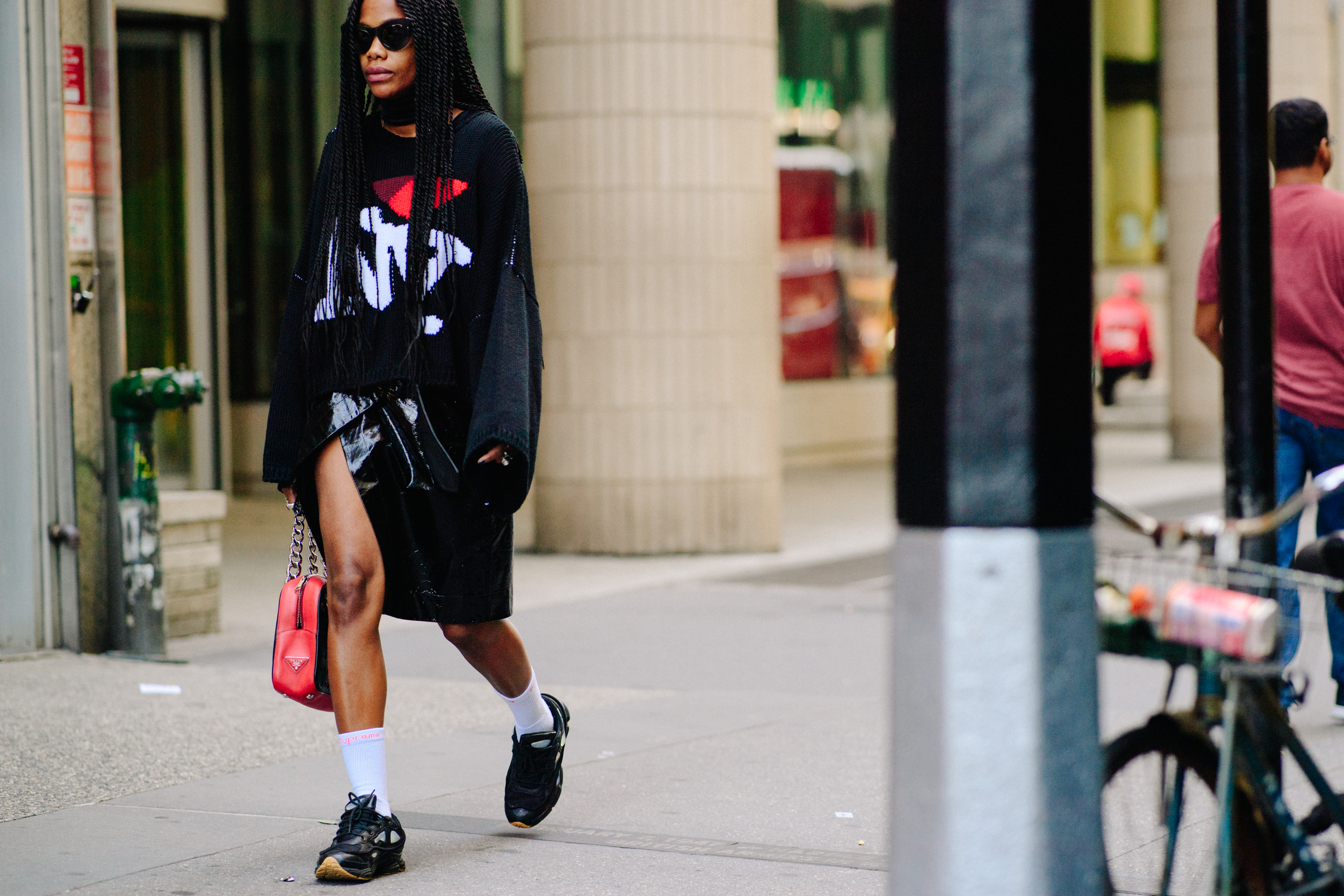 Editor wearing all blak and Ozweego sneakers