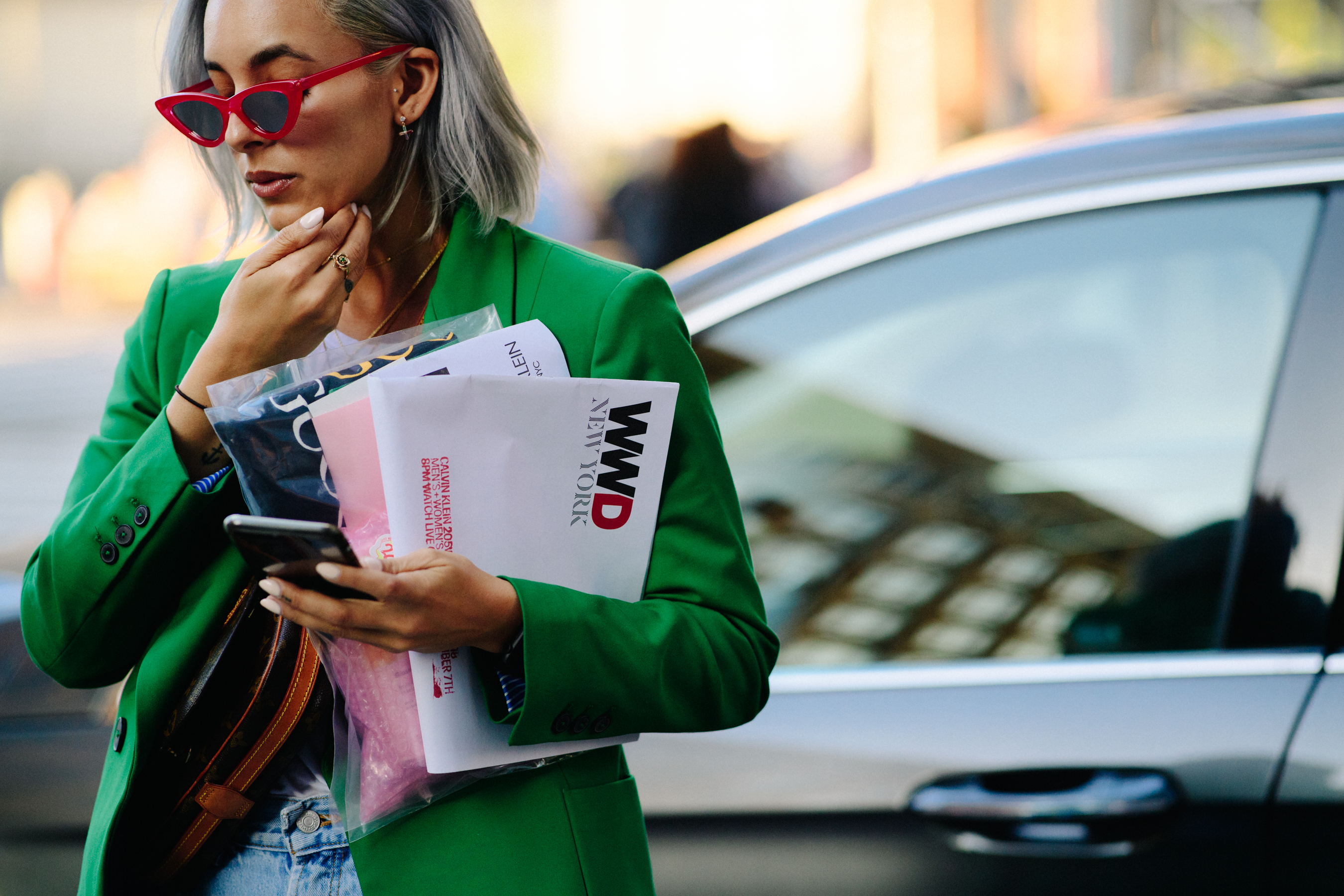 Woman wearing red glasses and green blazer