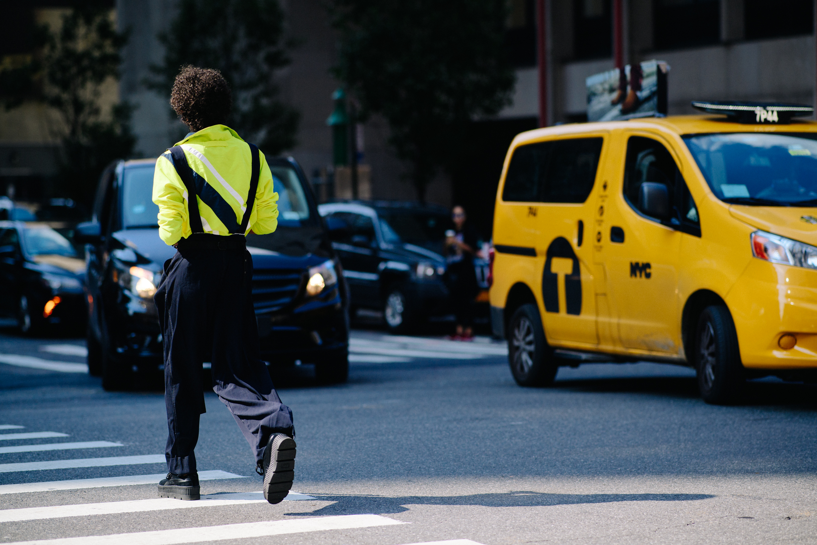 Man wearing neon shirt and black pants