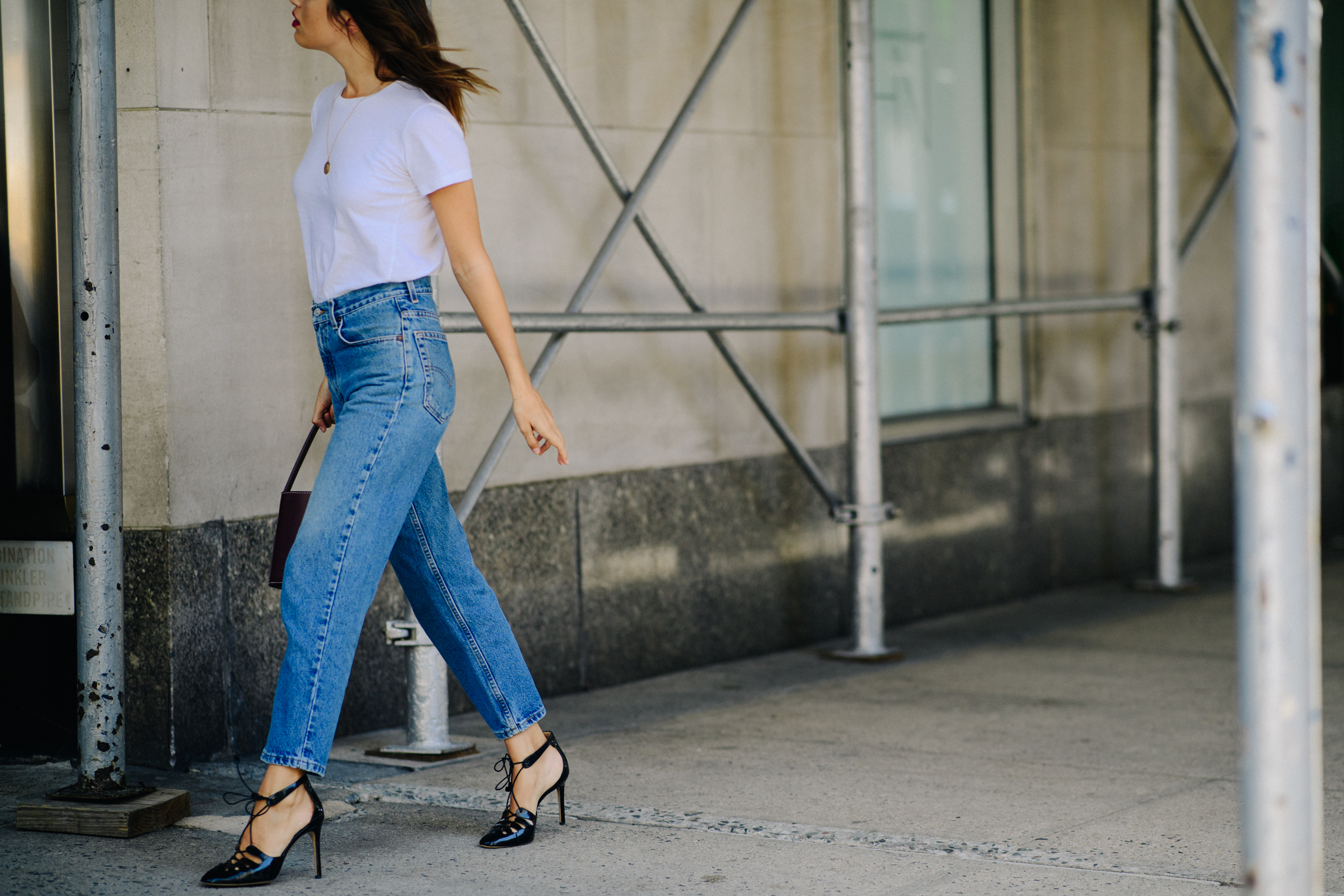 French woman wearing jeans and stilettos