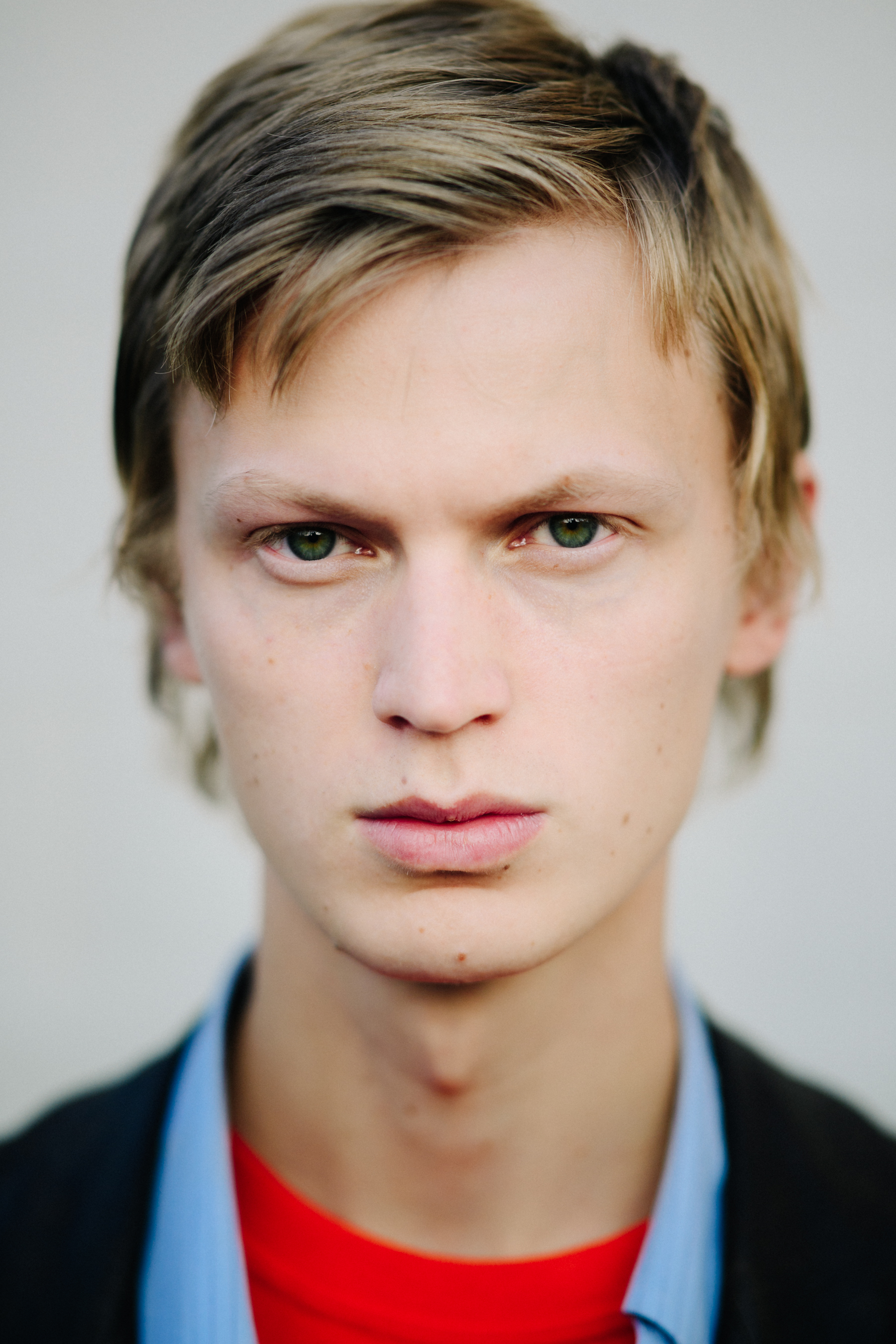 Portrait of male model with green eyes and short blonde hair