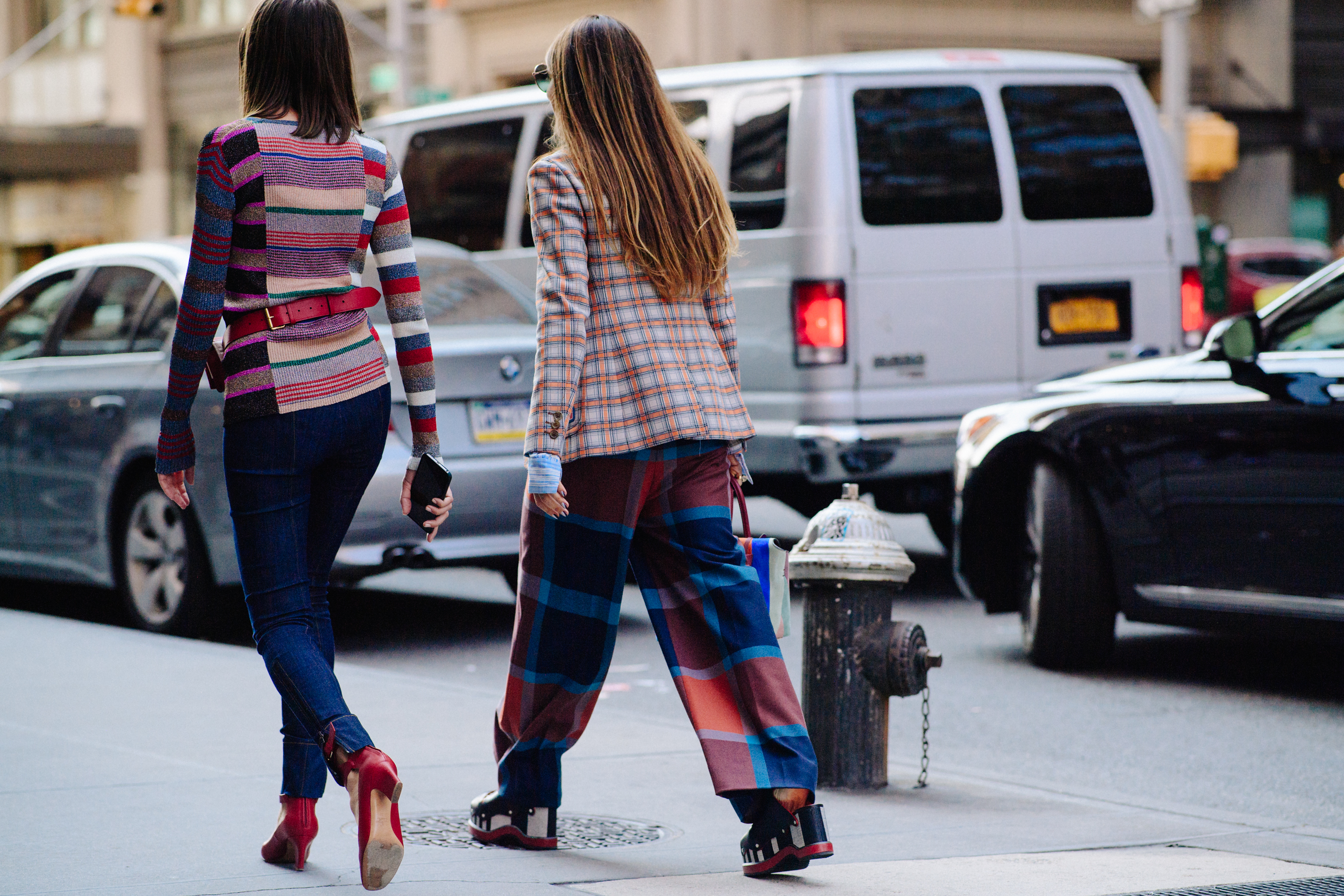 Two women wearing red and blue colours